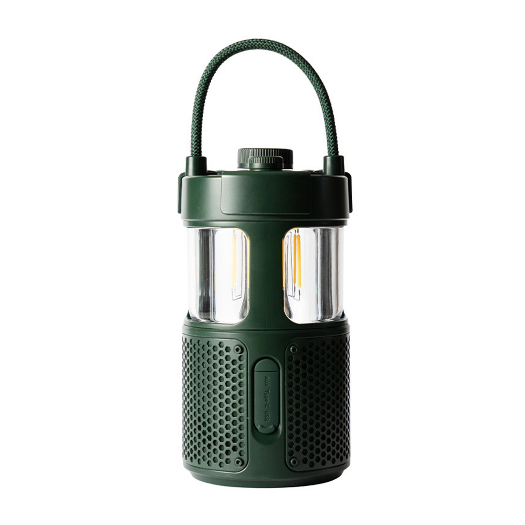 Ciemnozielona latarnia z uchwytem i głośnikiem na dole.