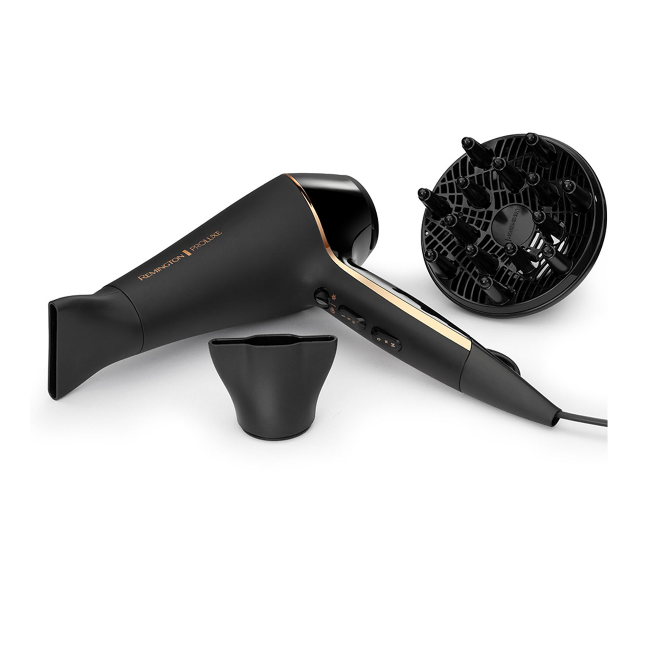 Czarna suszarka do włosów ze złotymi akcentami i akcesoriami.