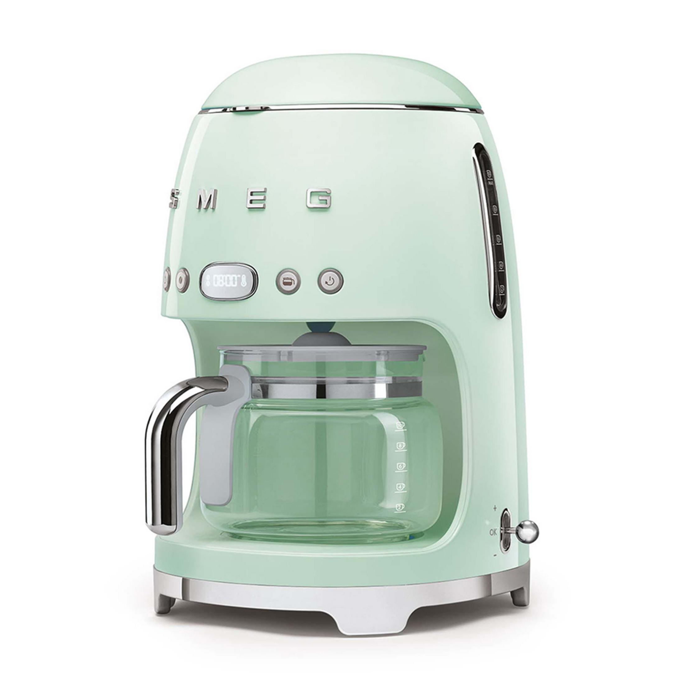 Macchina da caffè Smeg verde chiaro con caraffa in vetro e orologio digitale.