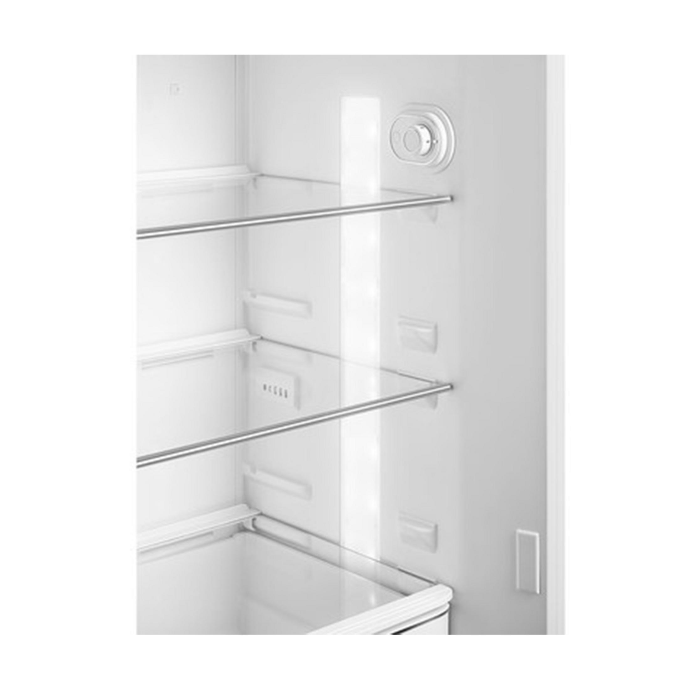 Interior de un refrigerador blanco con estantes de cristal y dial de temperatura.