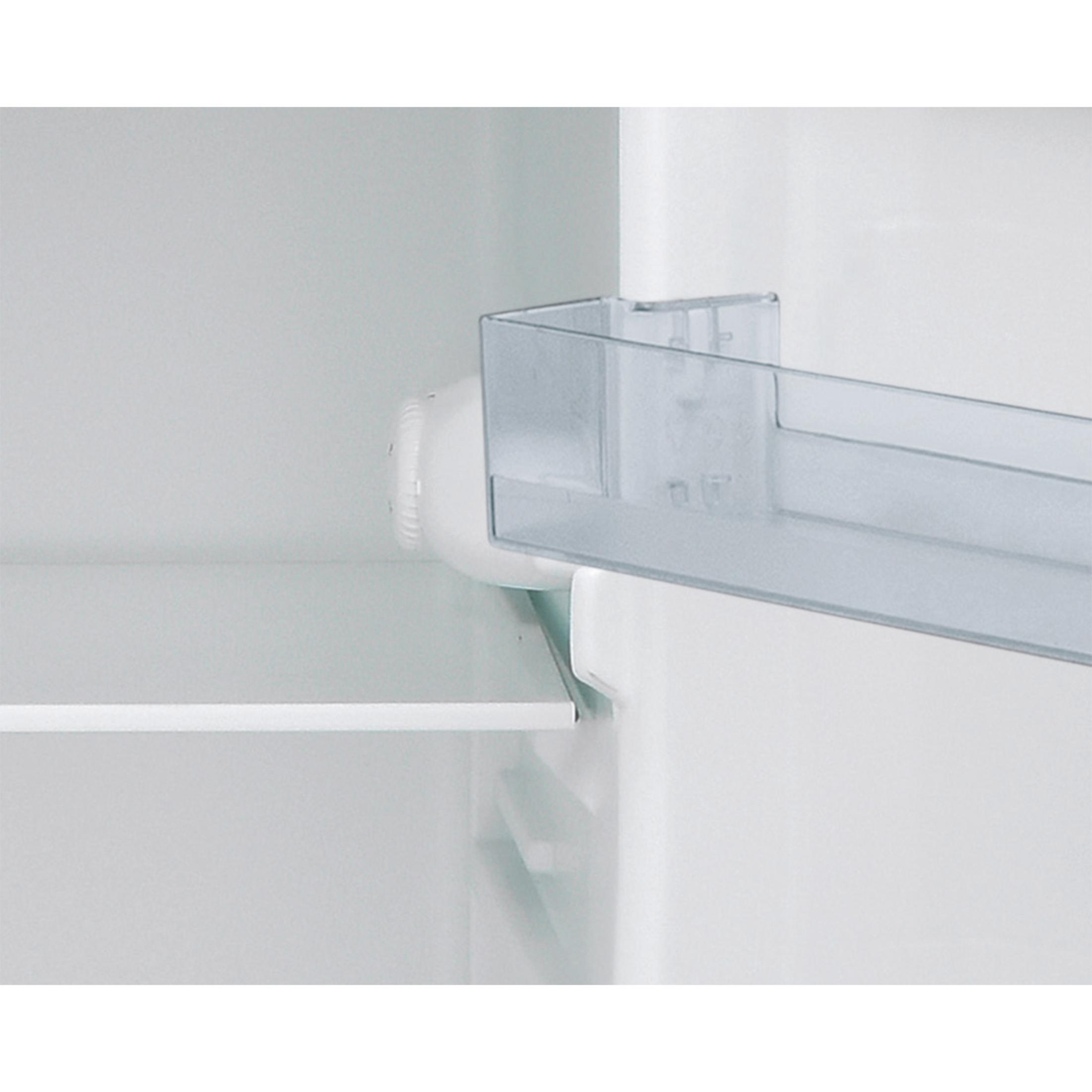 Primer plano de un estante de refrigerador con un contenedor transparente y un dial blanco.