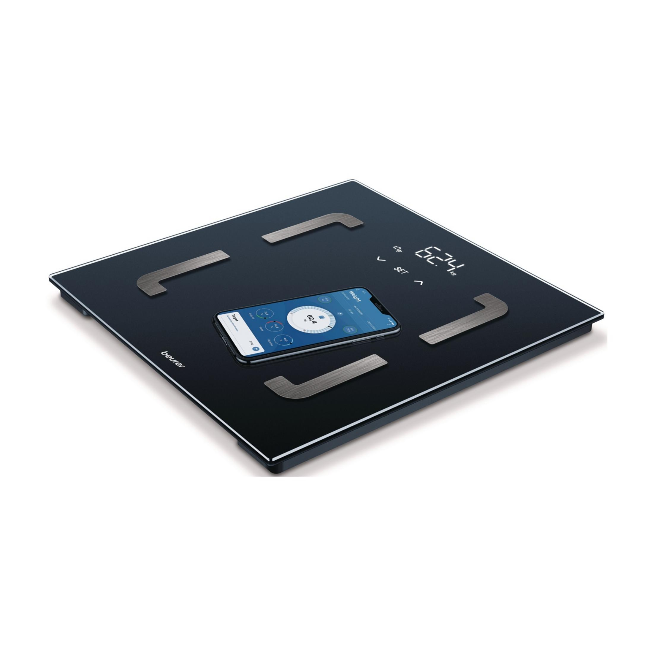 Bilancia personale nera con smartphone che mostra dati corporei. Peso totale 62,4 kg.