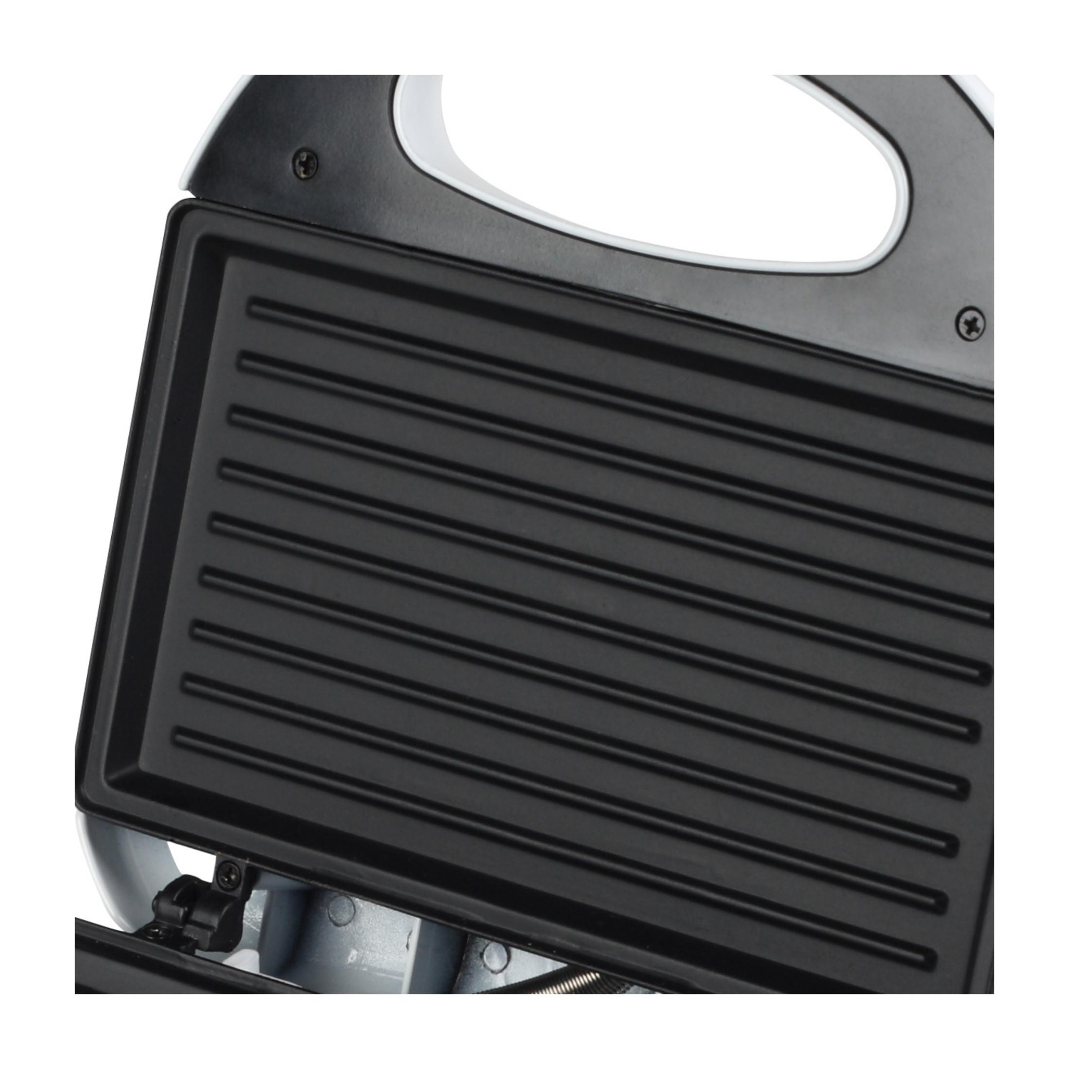 Widok z góry otwartej opiekacza do kanapek z płytami grillowymi.