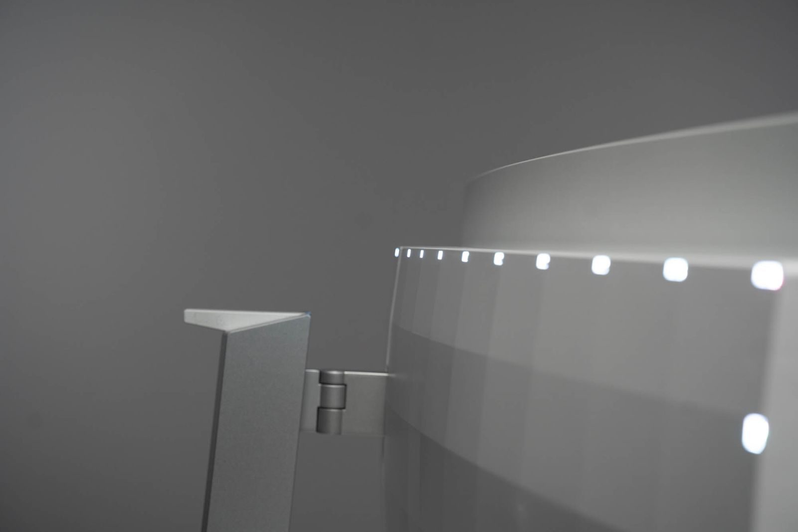 Zbliżenie białego urządzenia z lampkami i srebrną podstawą.