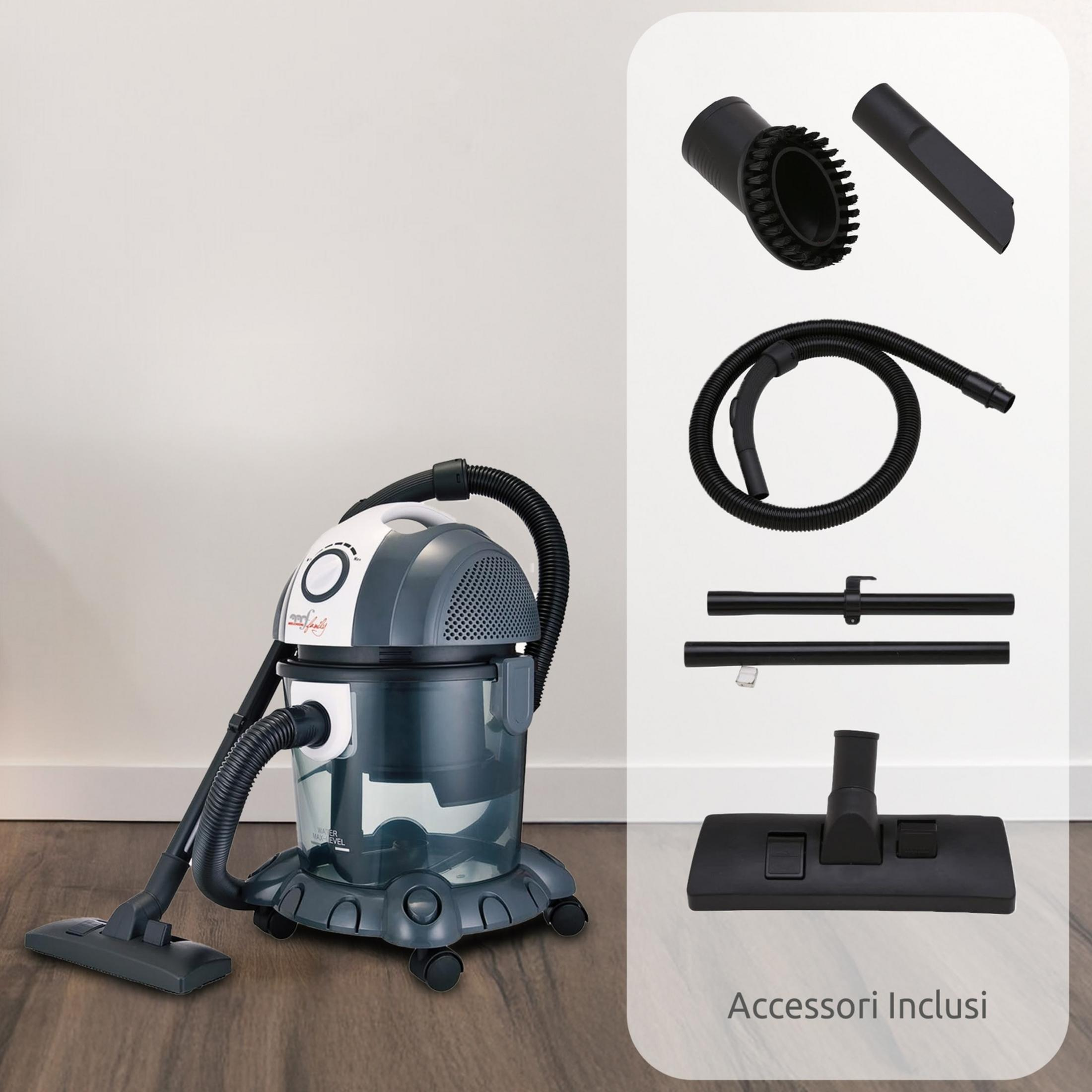Una aspiradora gris y blanca con accesorios sobre suelo de madera.