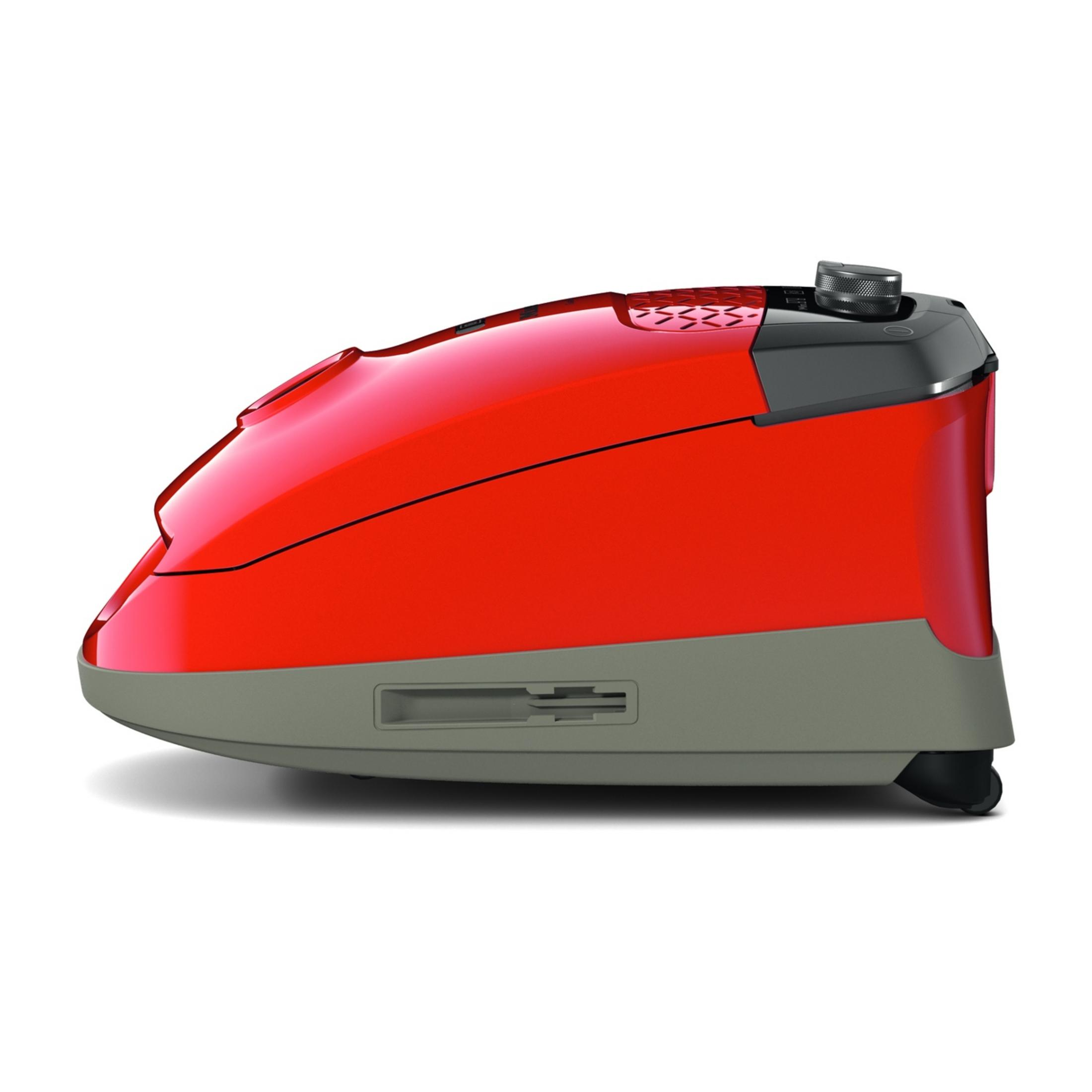 Roter und grauer Staubsauger mit schwarzem Drehknopf und Rädern.