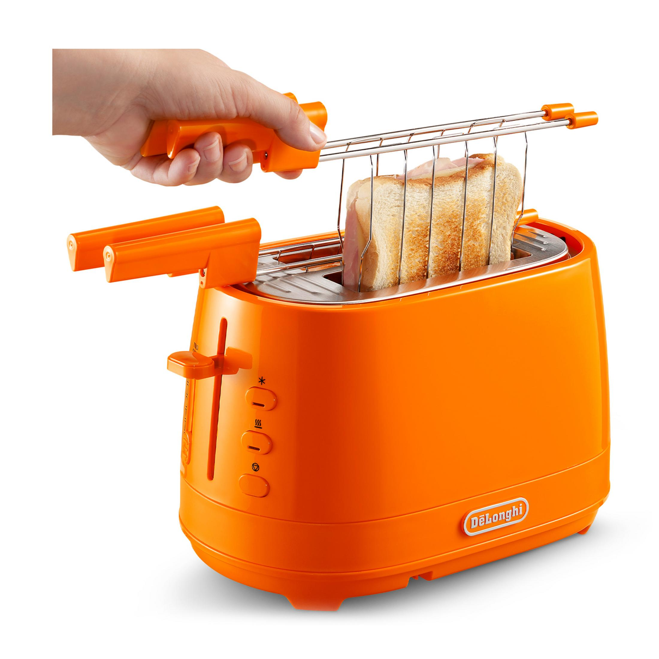 A hand operates an orange toaster with bread inside.