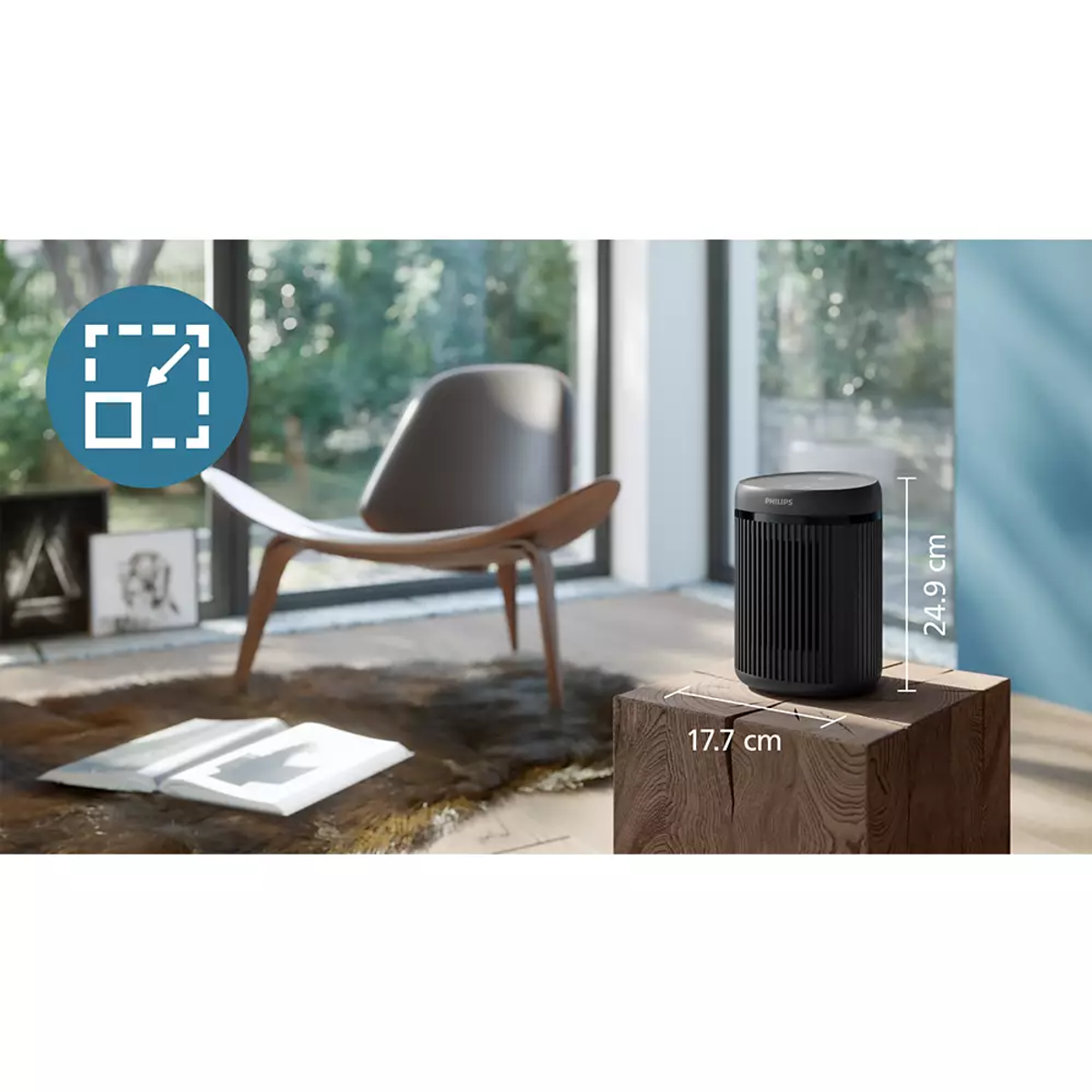 Czarny oczyszczacz powietrza Philips stoi na drewnianym sześcianie obok fotela.