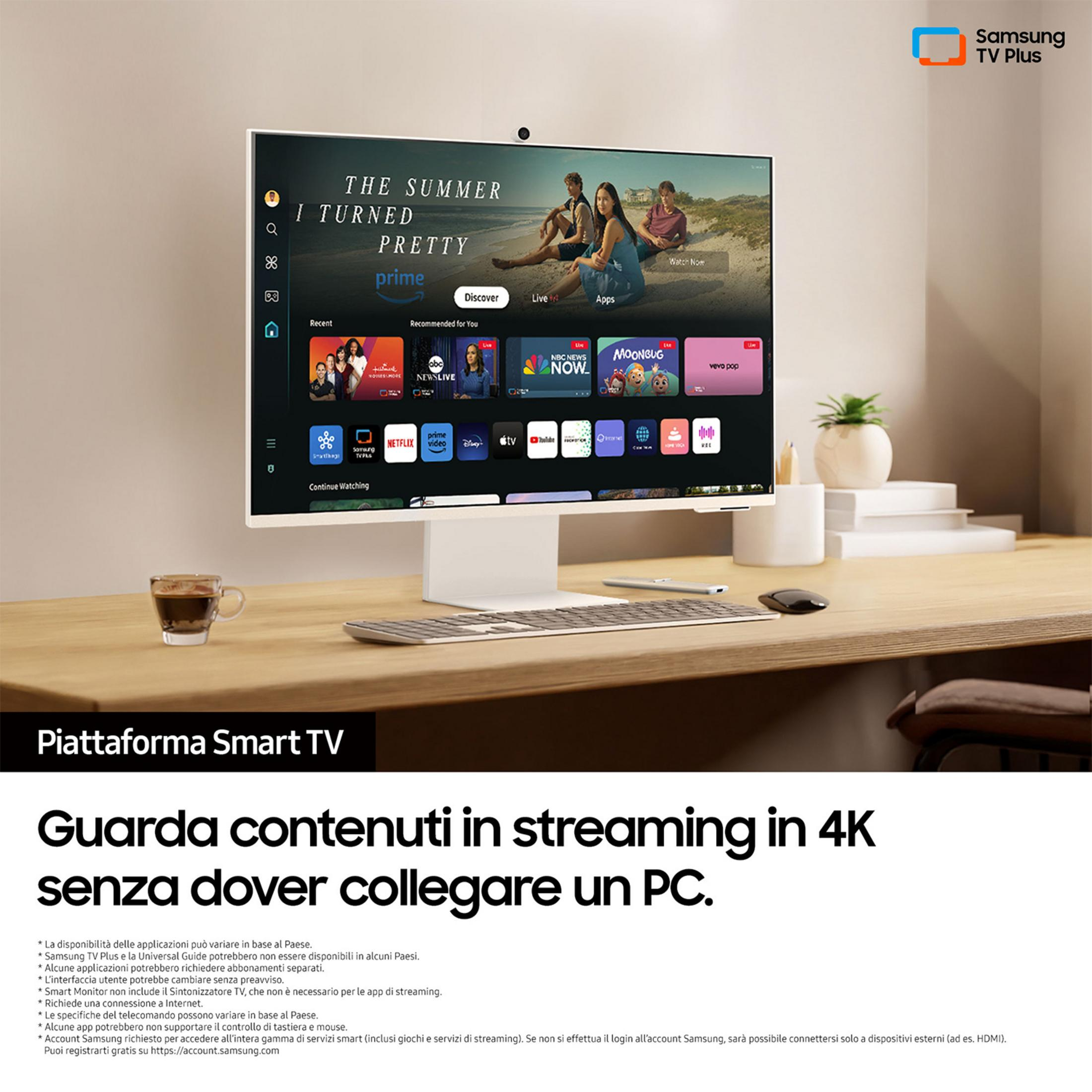Telewizor Samsung Smart TV wyświetla interfejs z filmami i aplikacjami na biurku.