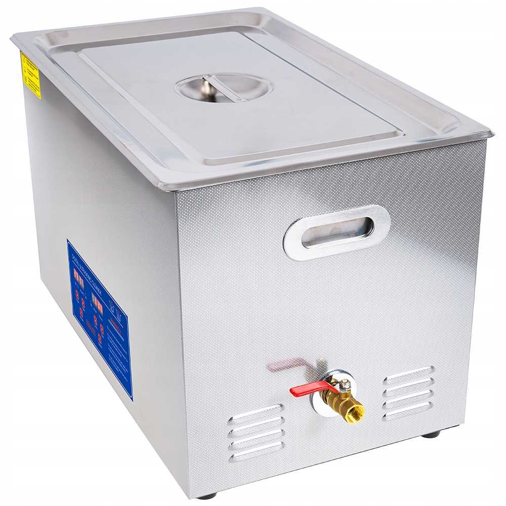 Stalowy czyściik ultradźwiękowy z uchwytami, zaworem spustowym i otworami wentylacyjnymi.