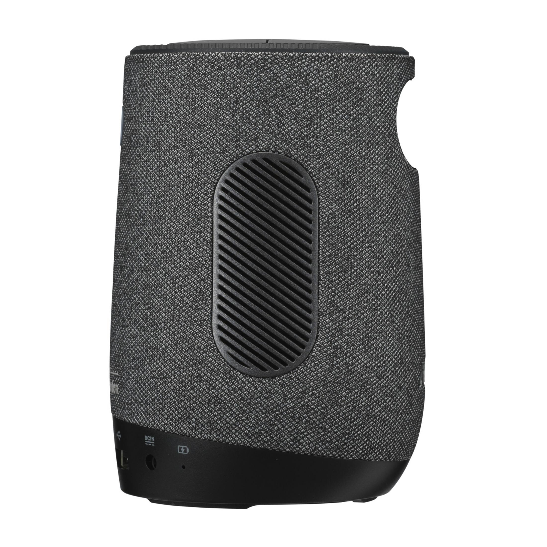 Gray fabric speaker with black grille and ports on the bottom.
