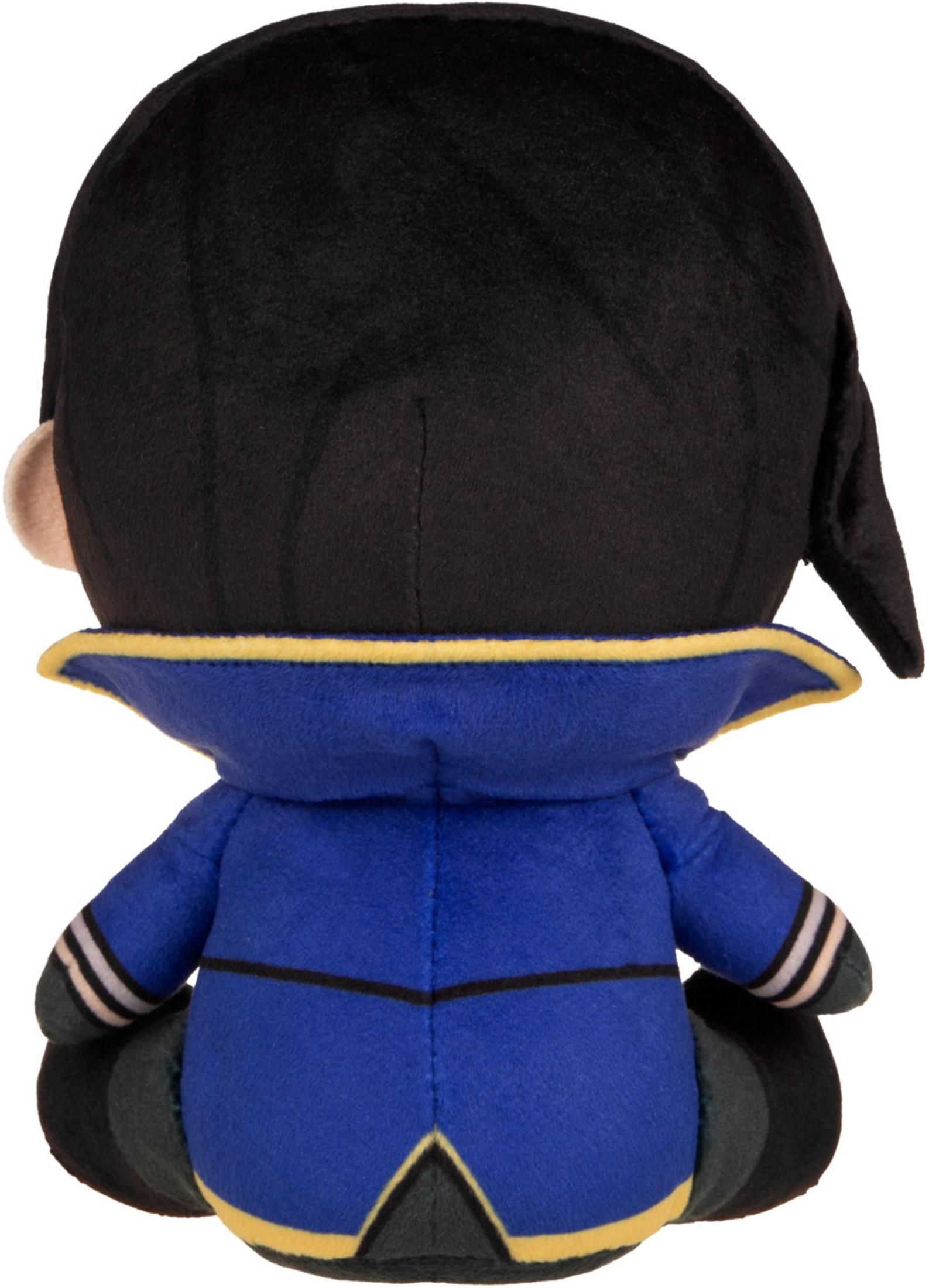 Plüschfigur mit schwarzem Haar, blauem Mantel und gelben Akzenten.