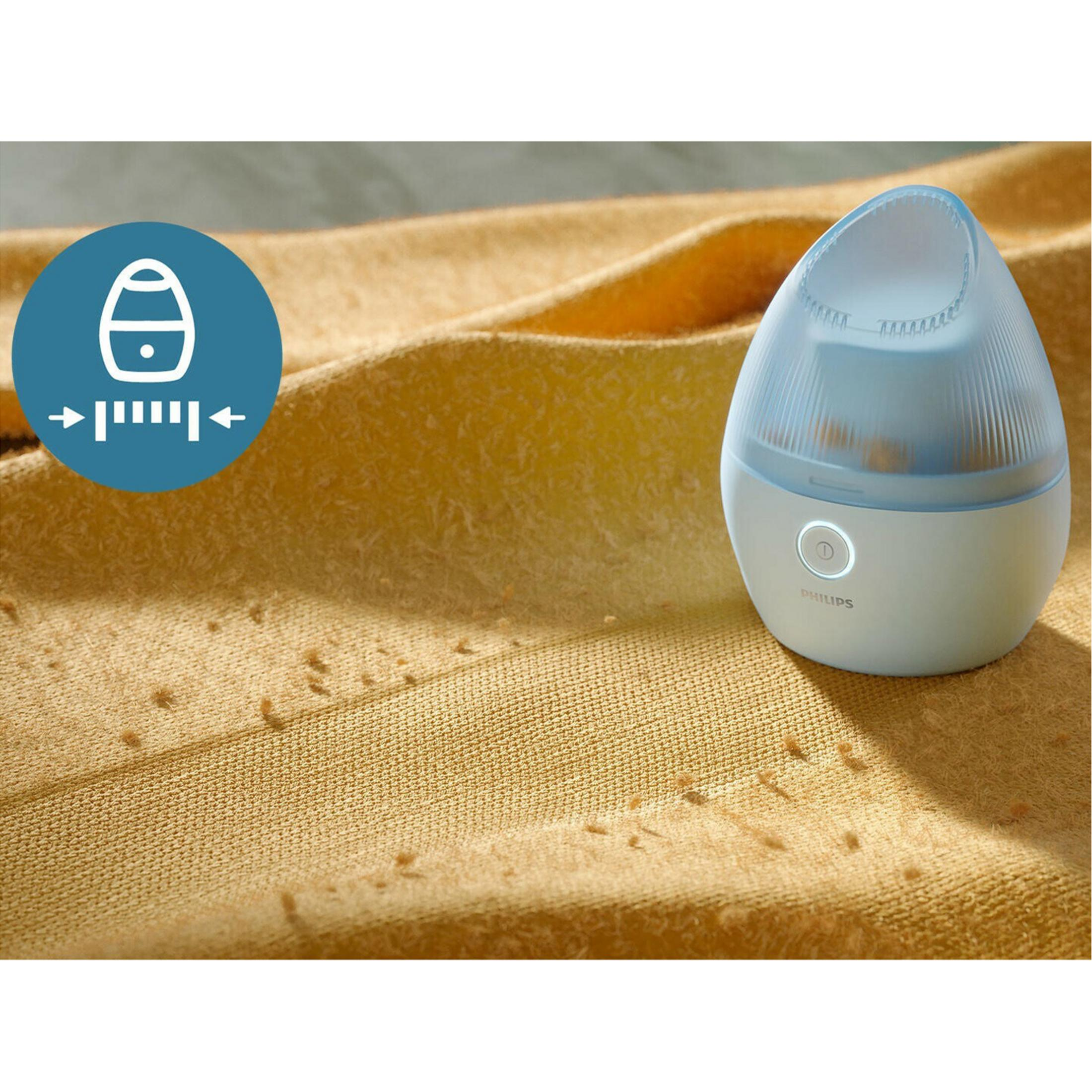 Sarı kumaş üzerinde Philips tüy giderici ve tiftikler.