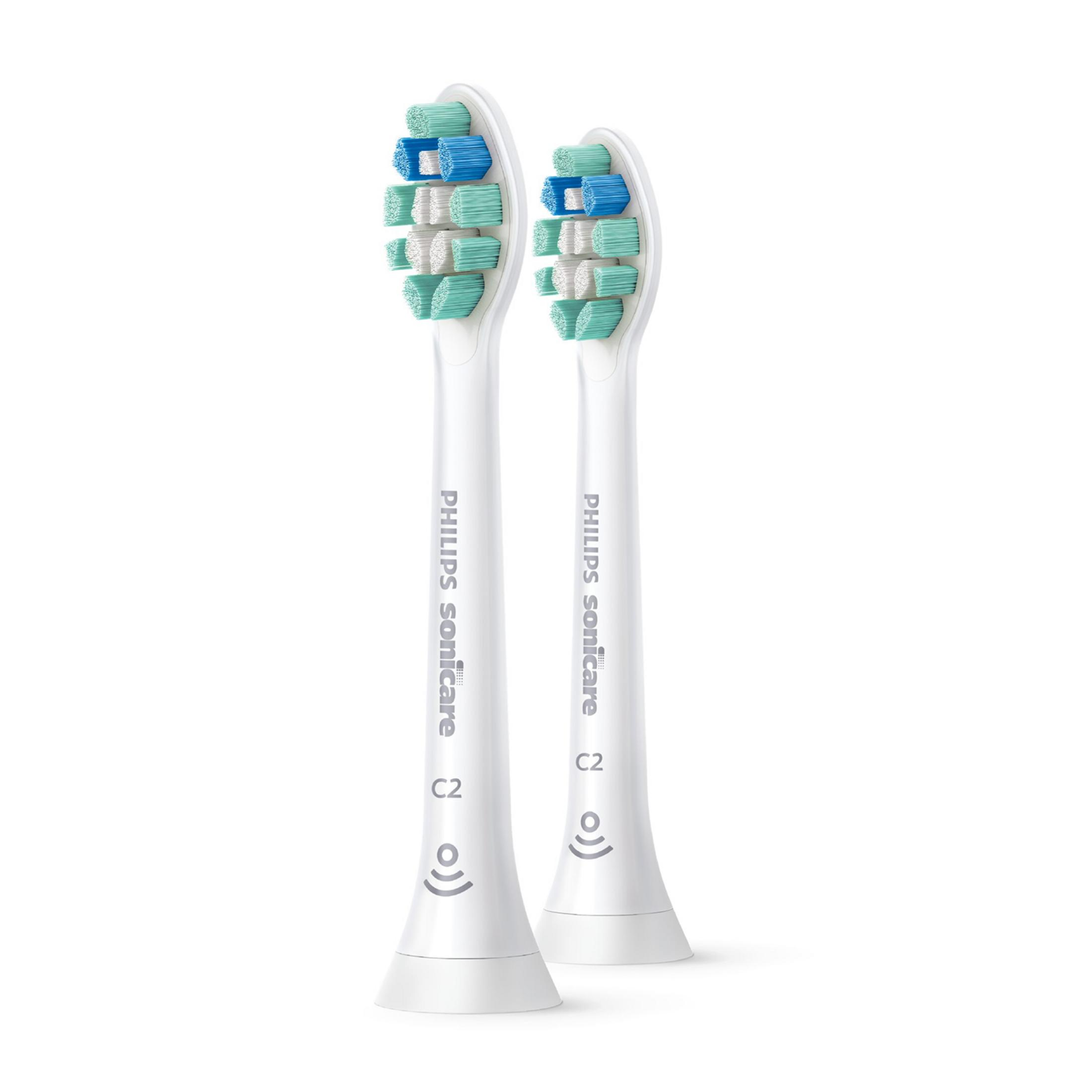Yeşil, mavi ve beyaz kıllara sahip iki beyaz Philips Sonicare diş fırçası başlığı.
