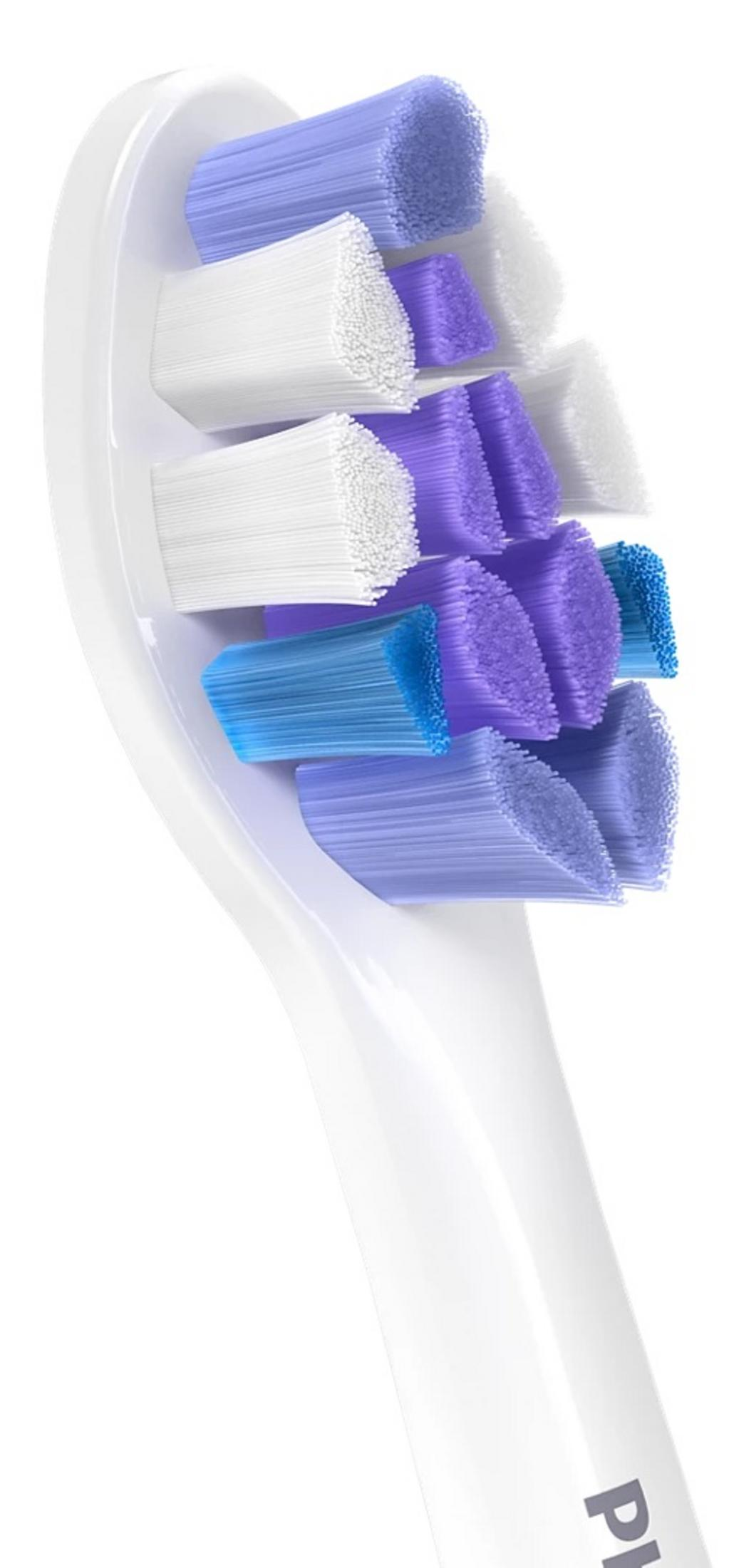 Nahaufnahme eines weißen Zahnbürstenkopfs mit blauen und violetten Borsten.