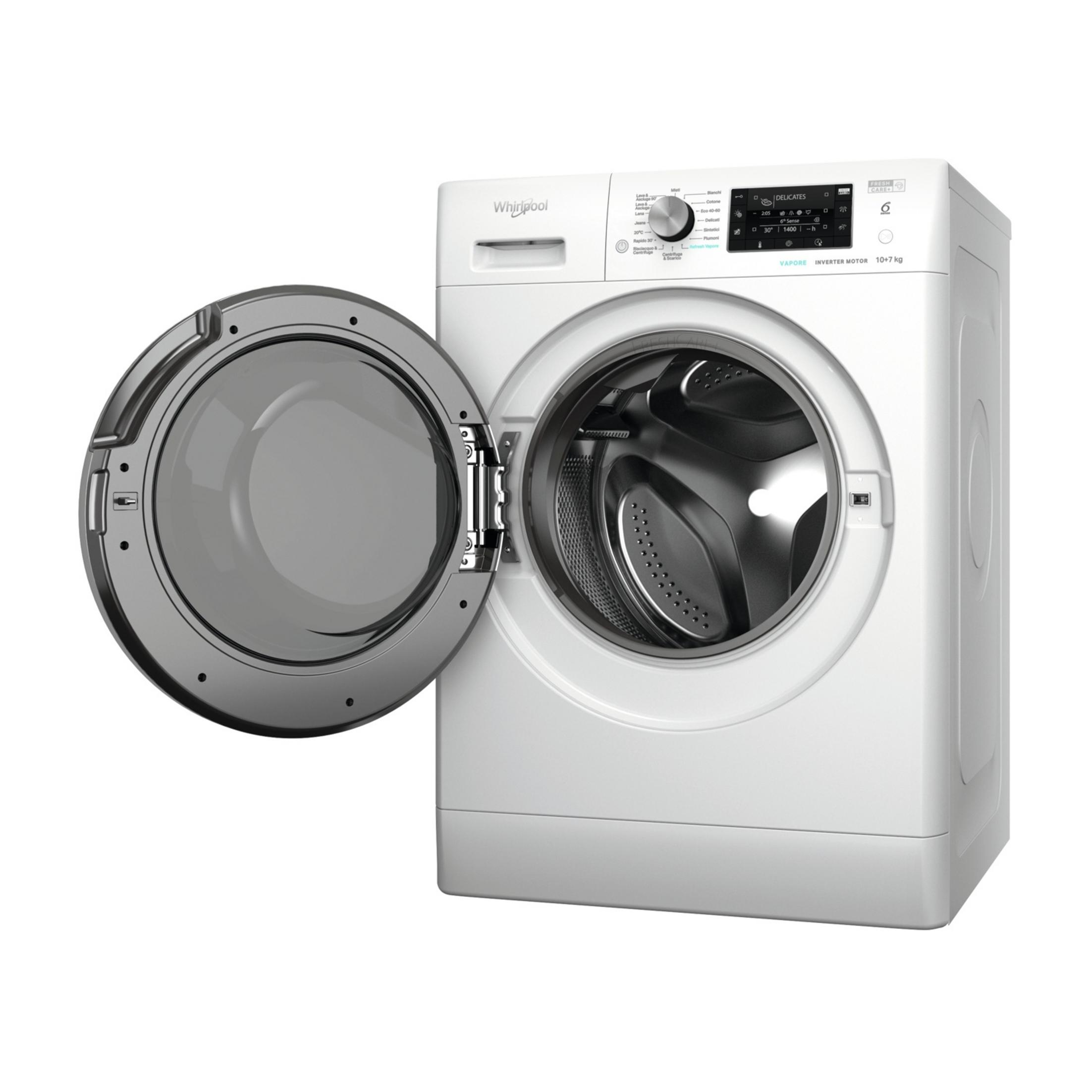 Una lavatrice Whirlpool bianca con oblò aperto, tamburo visibile.