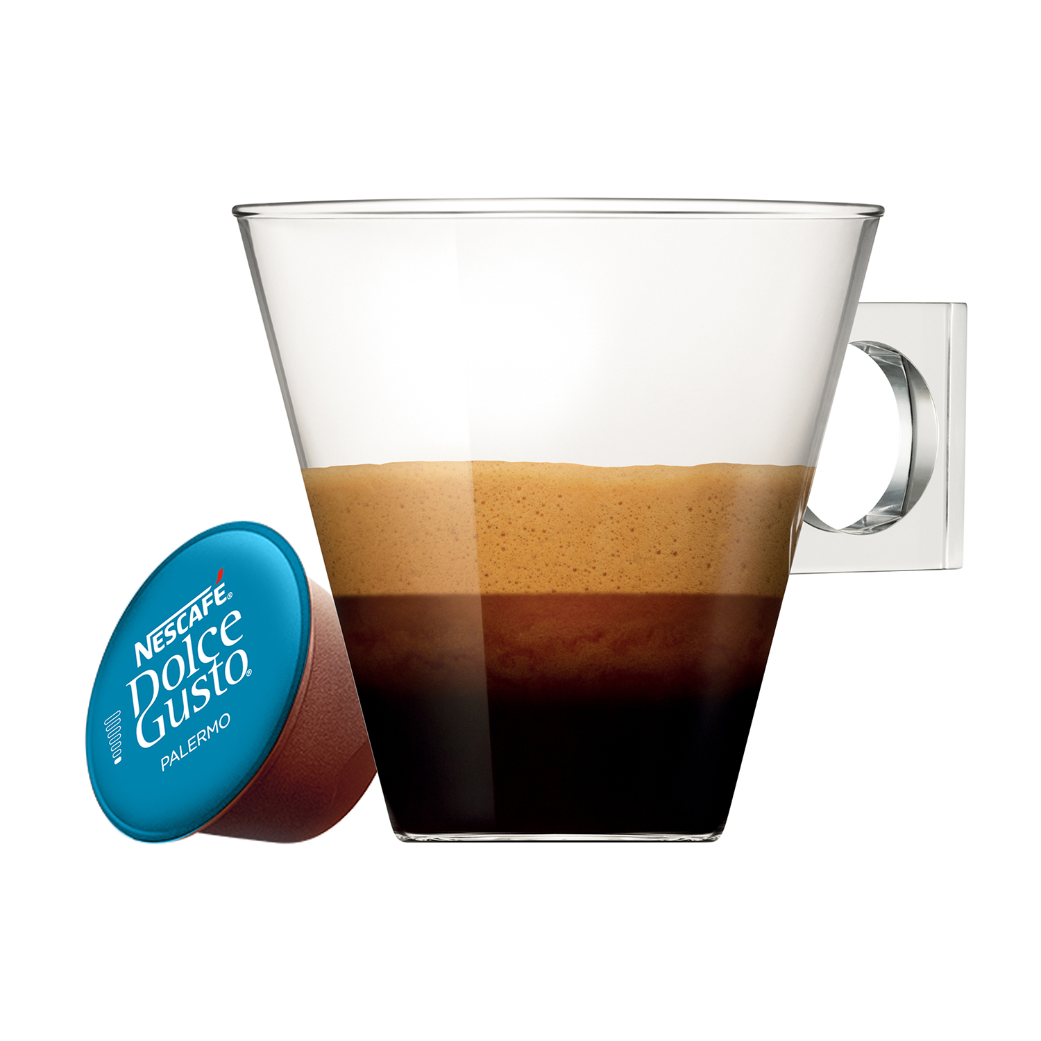 Una capsula Nespresso accanto a un bicchiere di espresso con schiuma marrone.