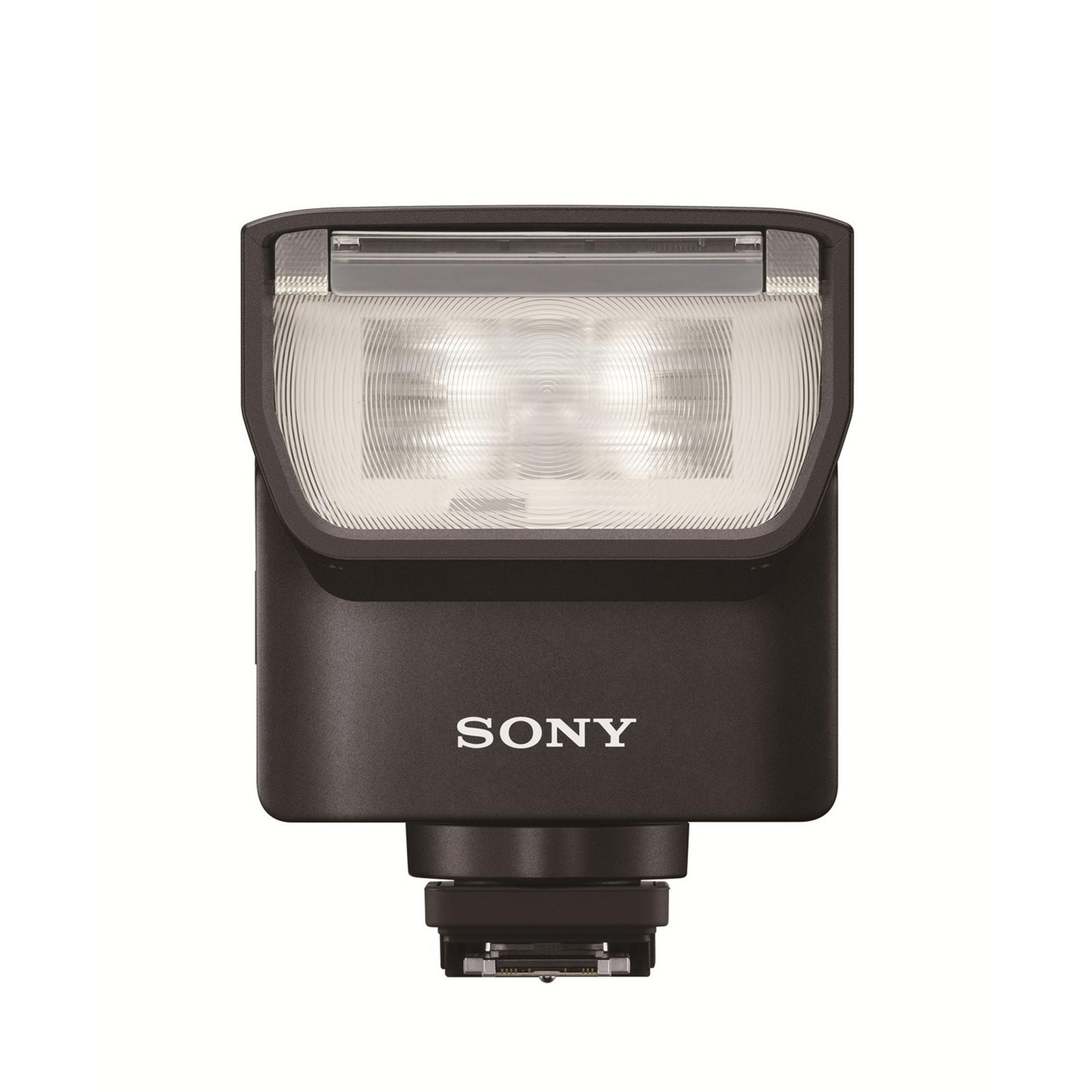 Un flash Sony scuro con parte superiore illuminata e piedino connettore.