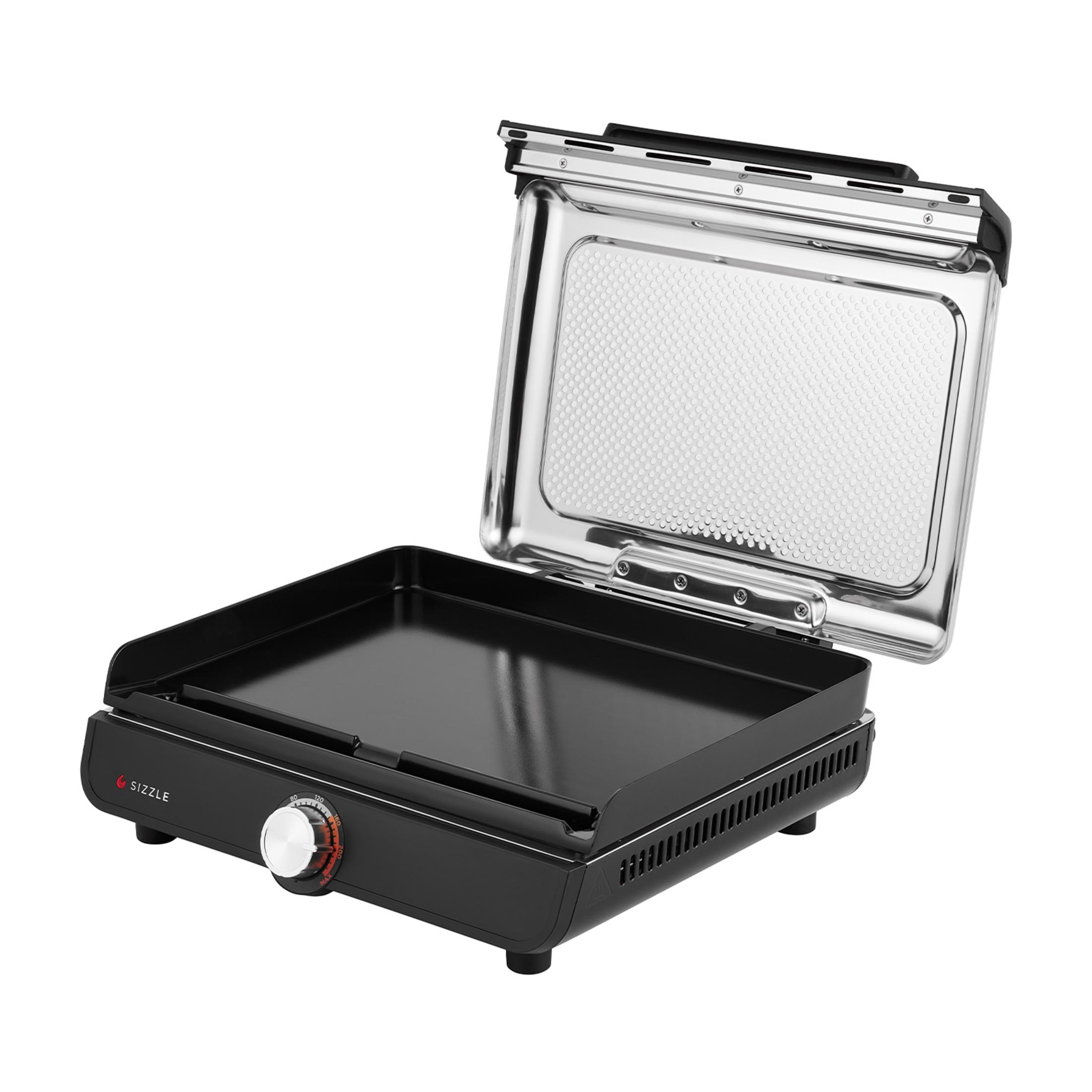 Czarny grill kontaktowy z otwartą pokrywą, pokazujący polerowane wnętrze.