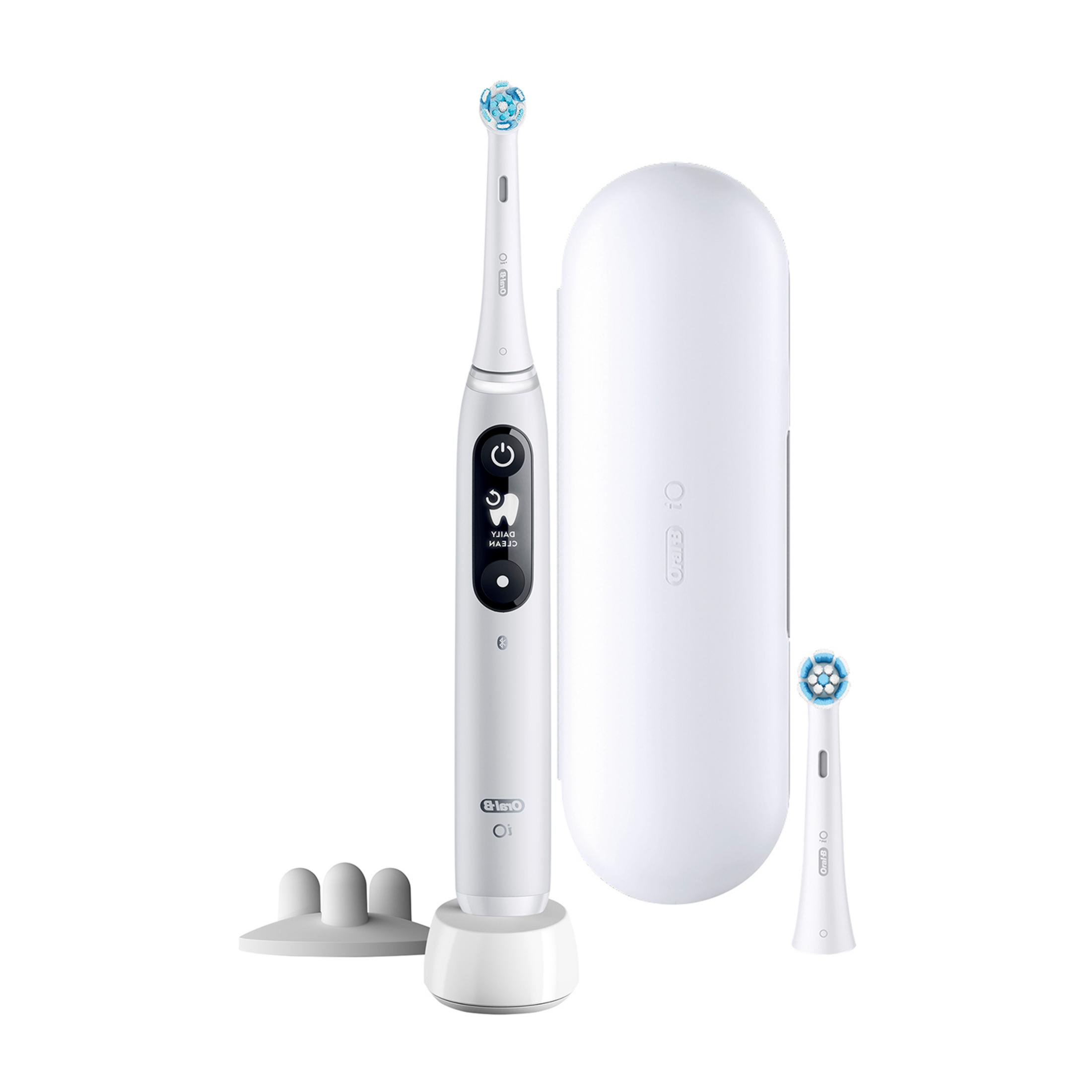 White electric toothbrush with charging case, brush head, and holder.