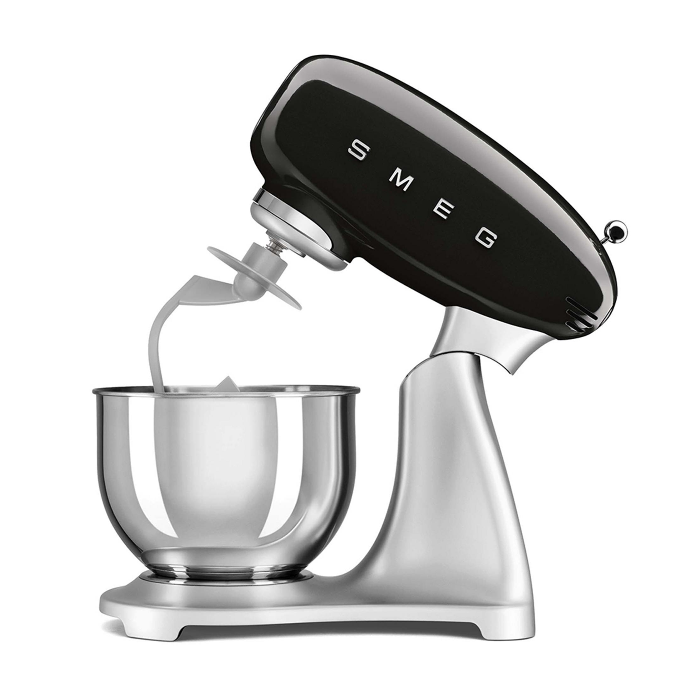 Black SMEG stand mixer with silver bowl and beater attachment.