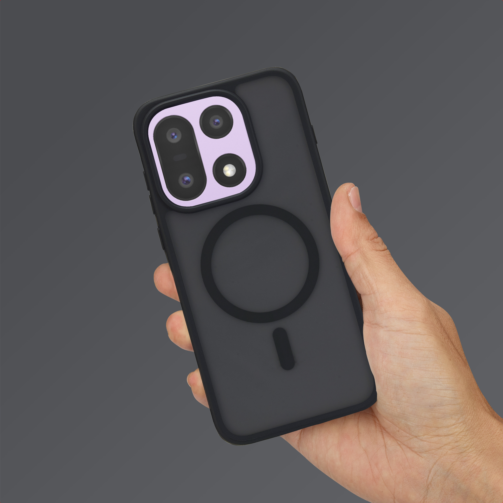Une main tient un smartphone sombre avec un objectif photo violet clair proéminent.