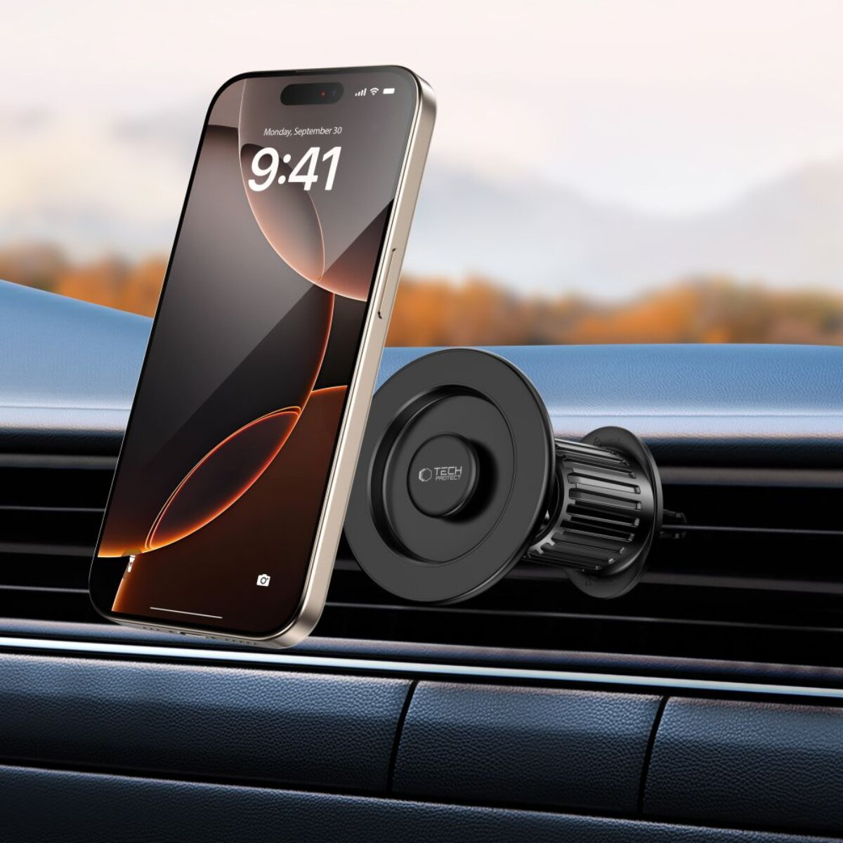 Ein Smartphone an einem magnetischen Auto-Luftauslasshalter. Der Hintergrund ist unscharf.