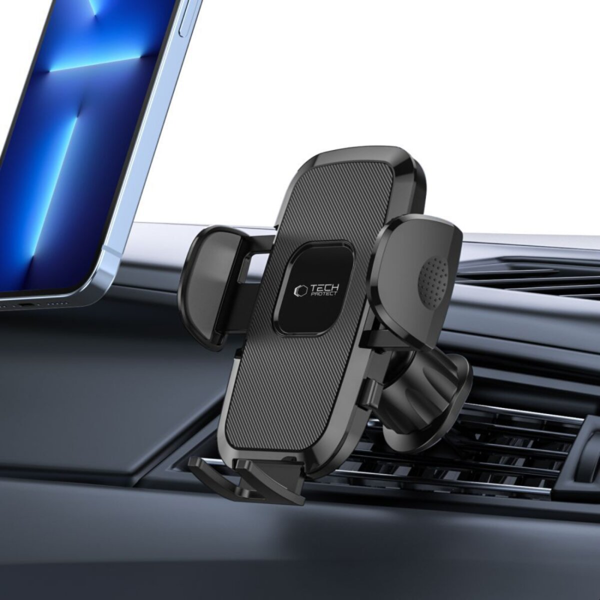 Ein schwarzer Autohalter mit Handy auf einem Armaturenbrett.