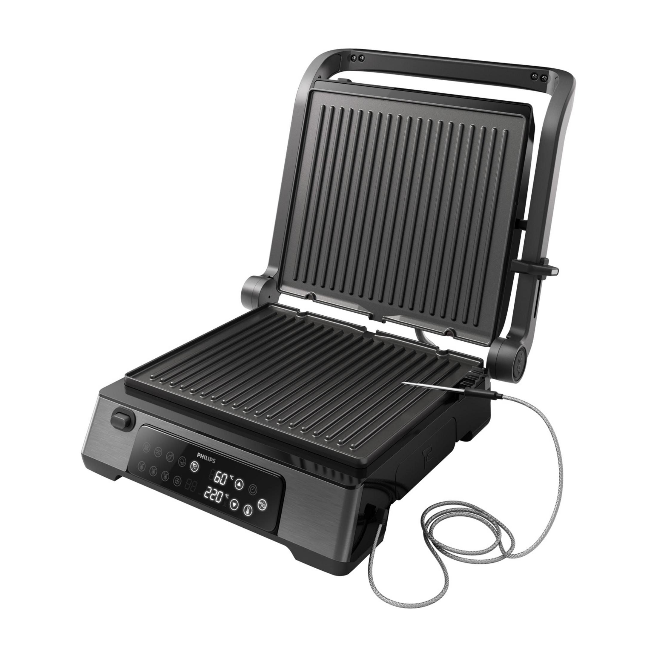 Otwarty, ciemny grill kontaktowy z sondą temperatury i cyfrowym wyświetlaczem.