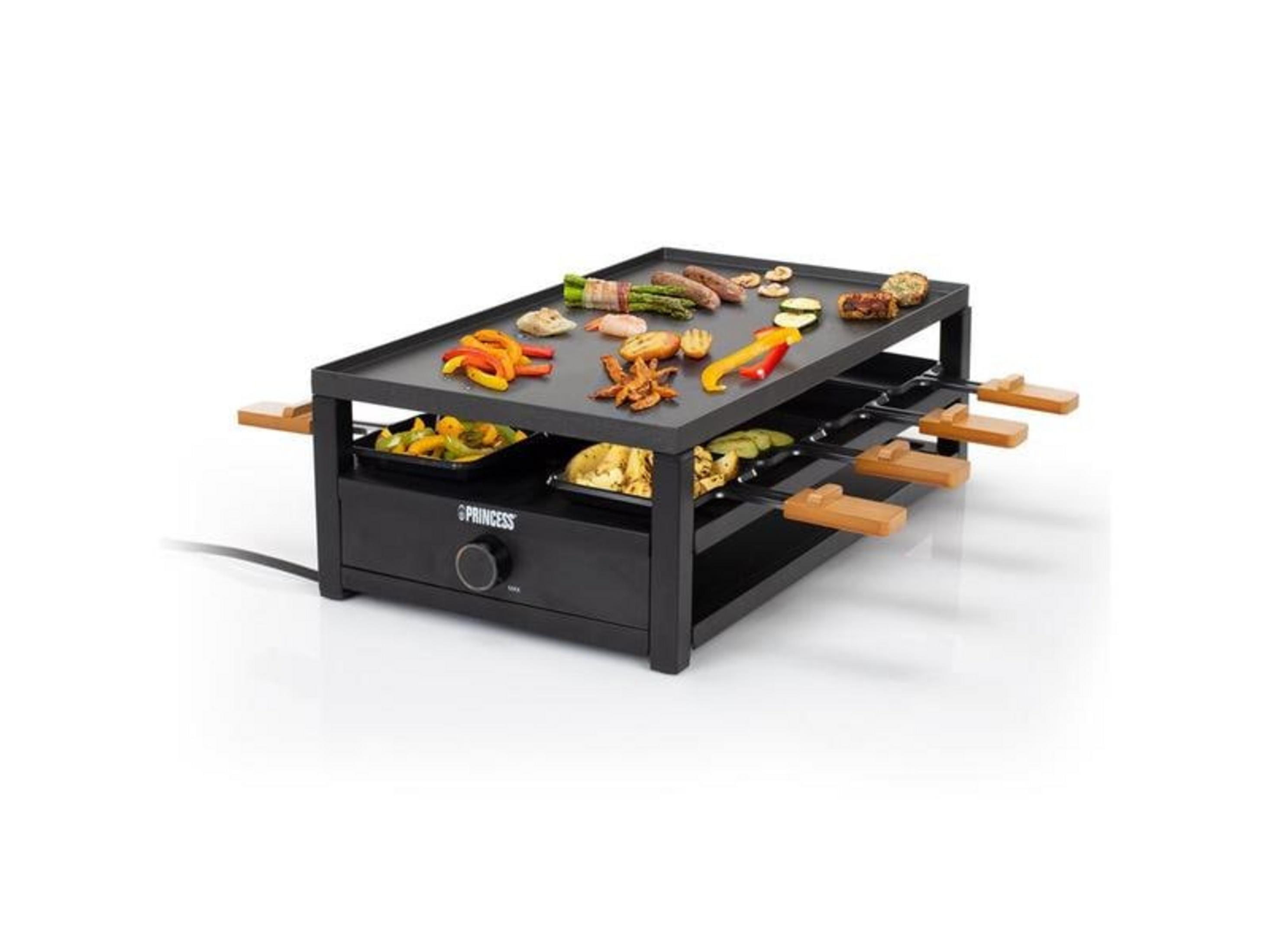 Ein Raclettegrill mit Speisen wie Würstchen, Paprika und Spargel.