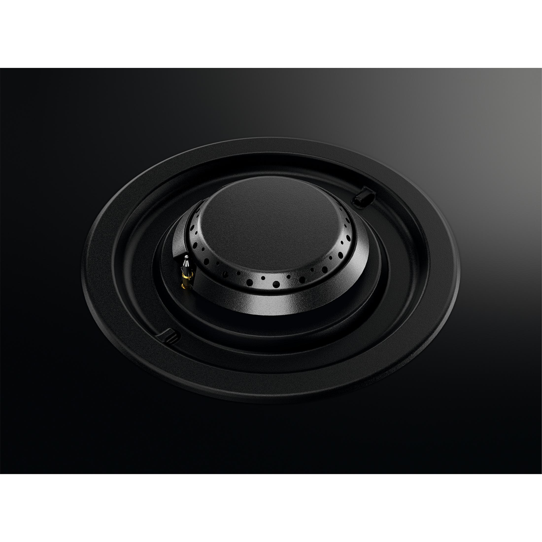 Czarny palnik kuchenki gazowej z małymi otworami i bolcem zapłonowym.