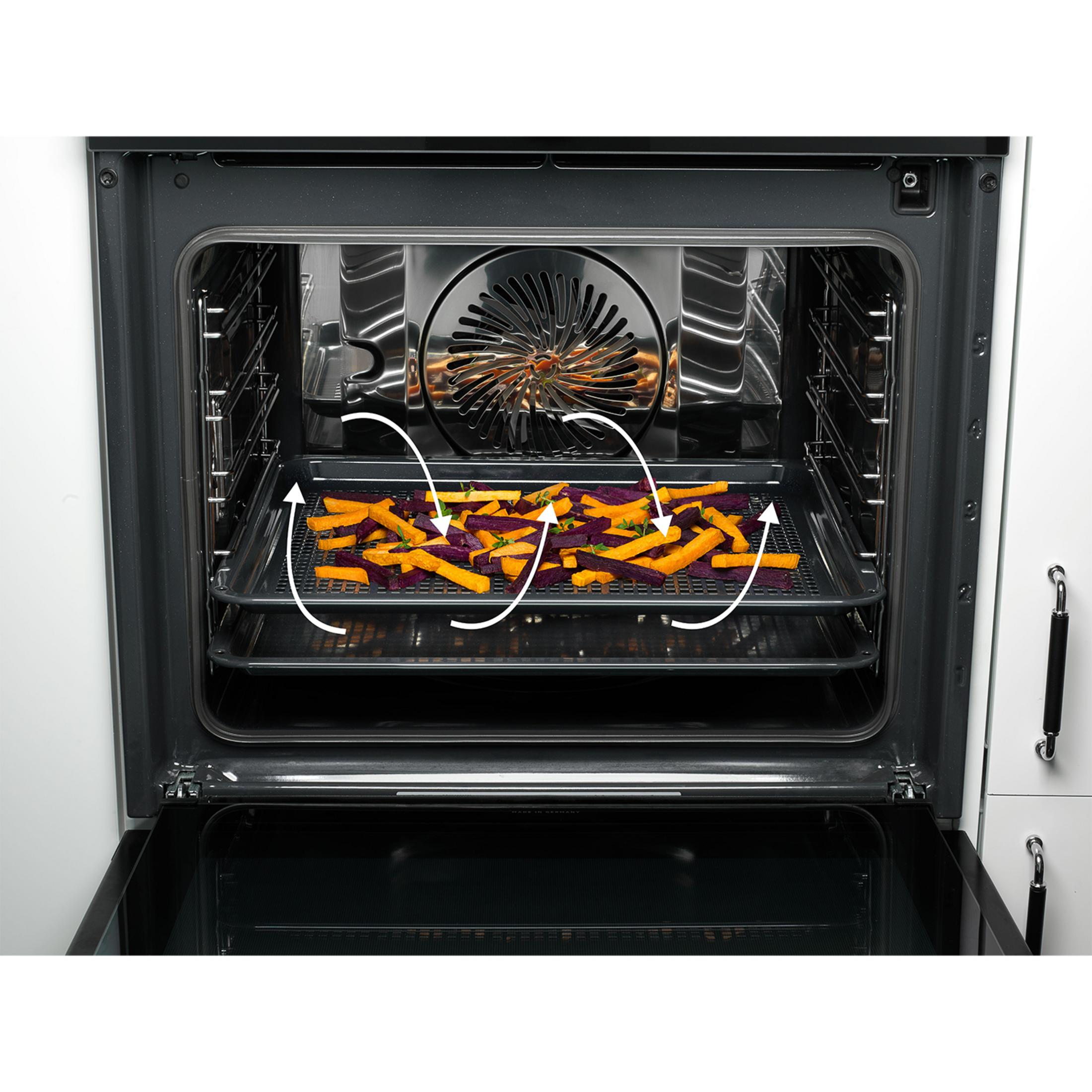 Verdure su una griglia in un forno con frecce che mostrano la circolazione dell'aria.