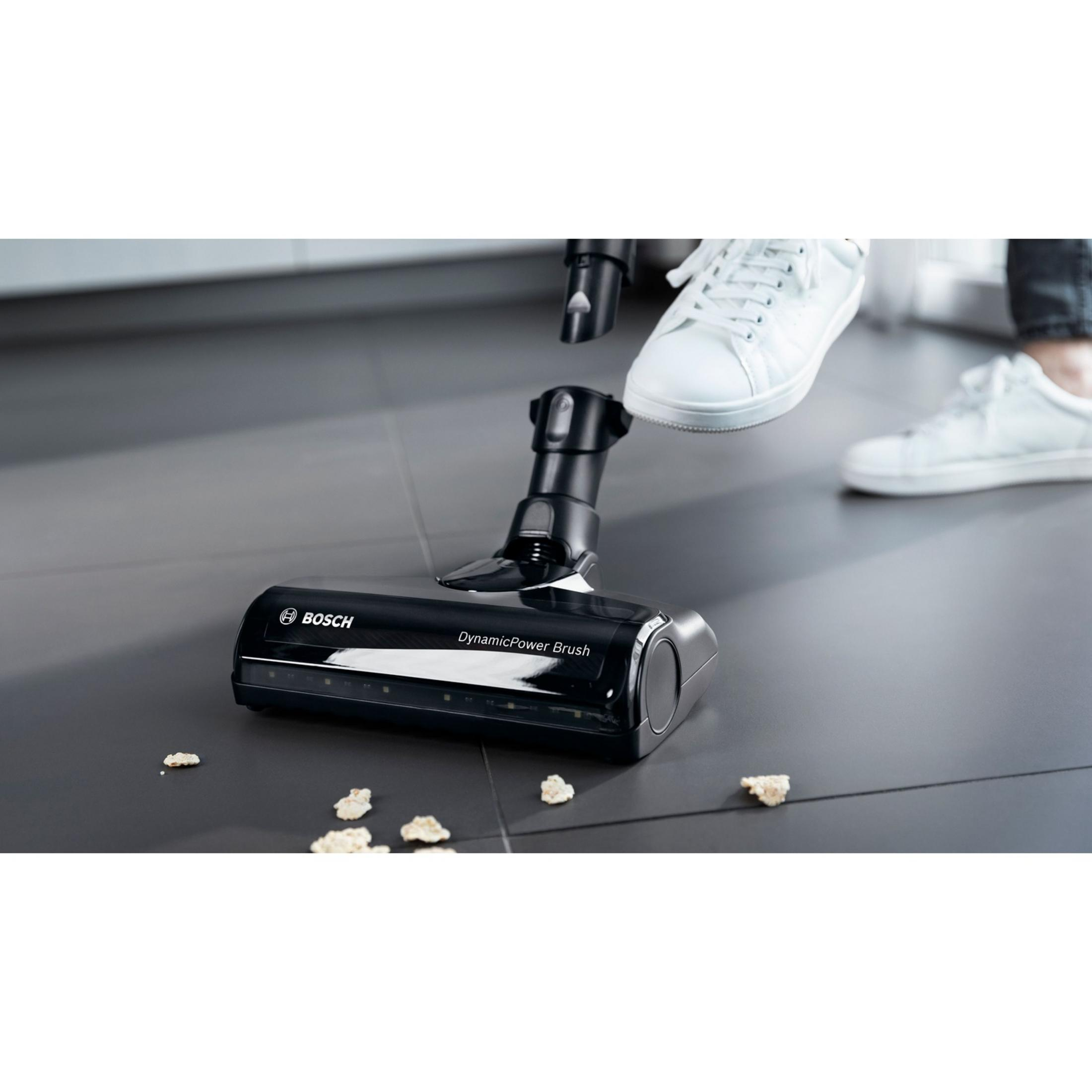Tête d'aspirateur Bosch noire "DynamicPower Brush" sur sol sombre.