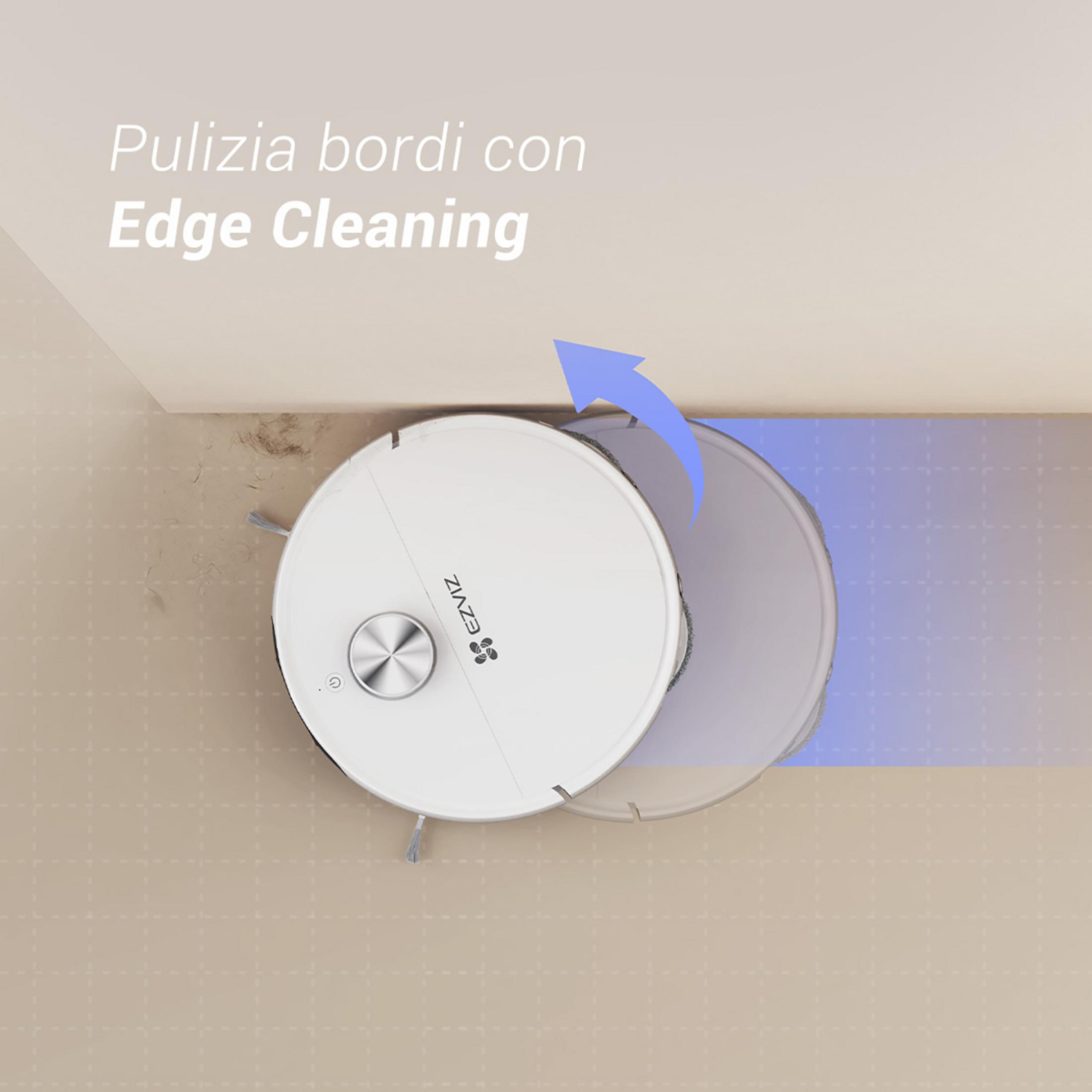 Un robot aspirador blanco limpia el borde de una habitación con sus cepillos.