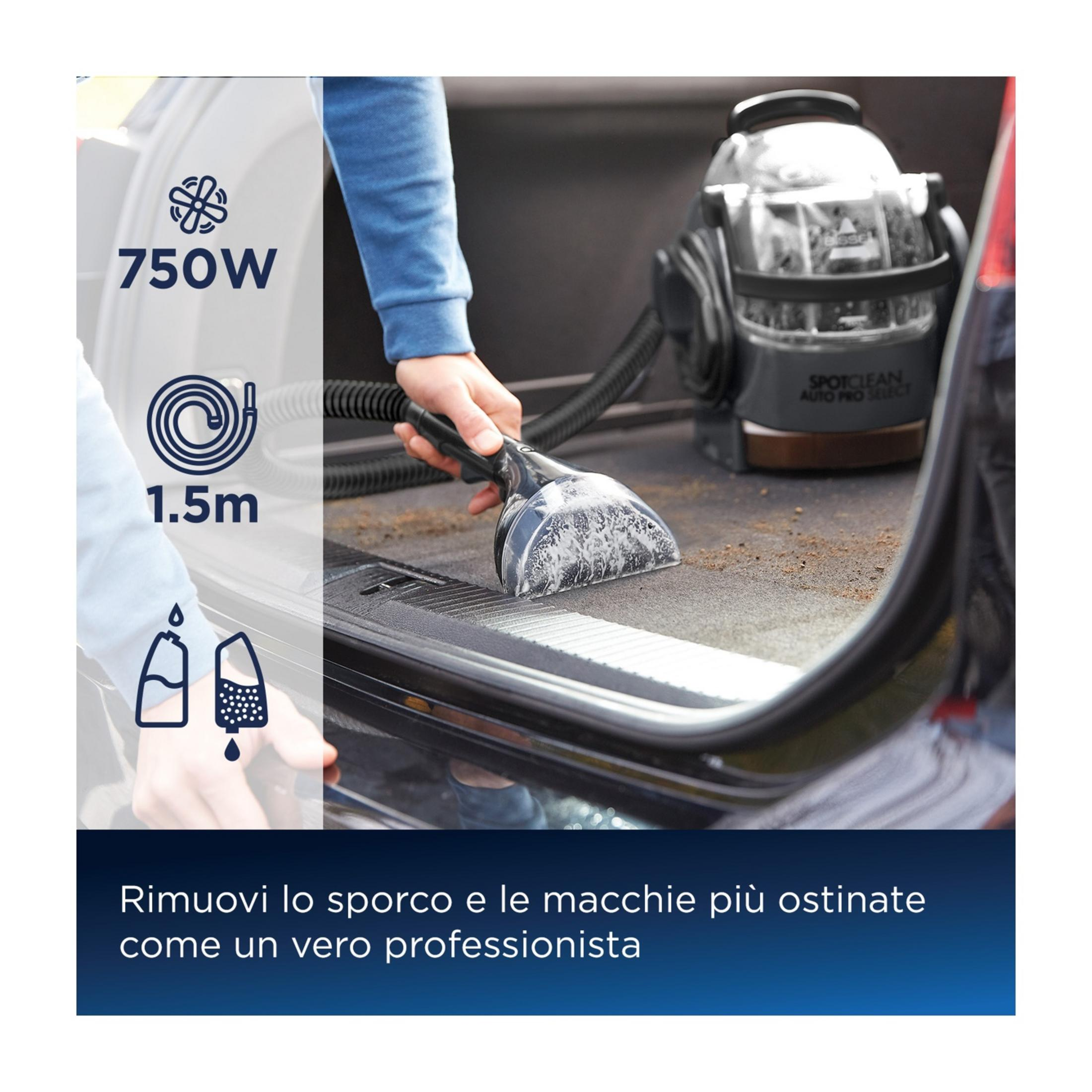 Osoba czyści bagażnik samochodu przenośnym odkurzaczem.