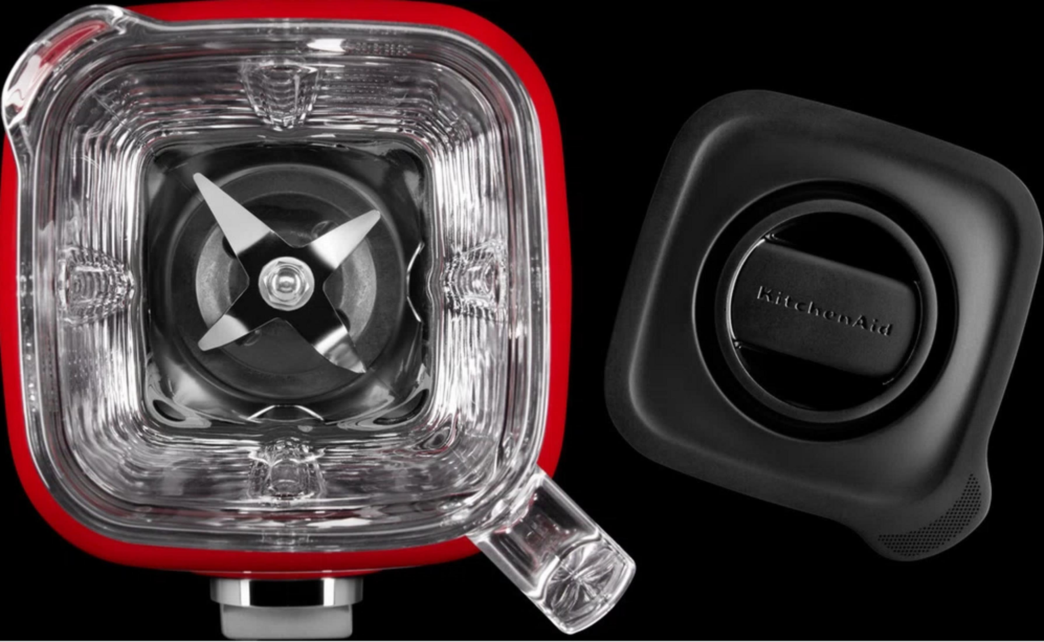 Ein roter Mixerbehälter mit Klingen und ein schwarzer Deckel mit KitchenAid-Logo.