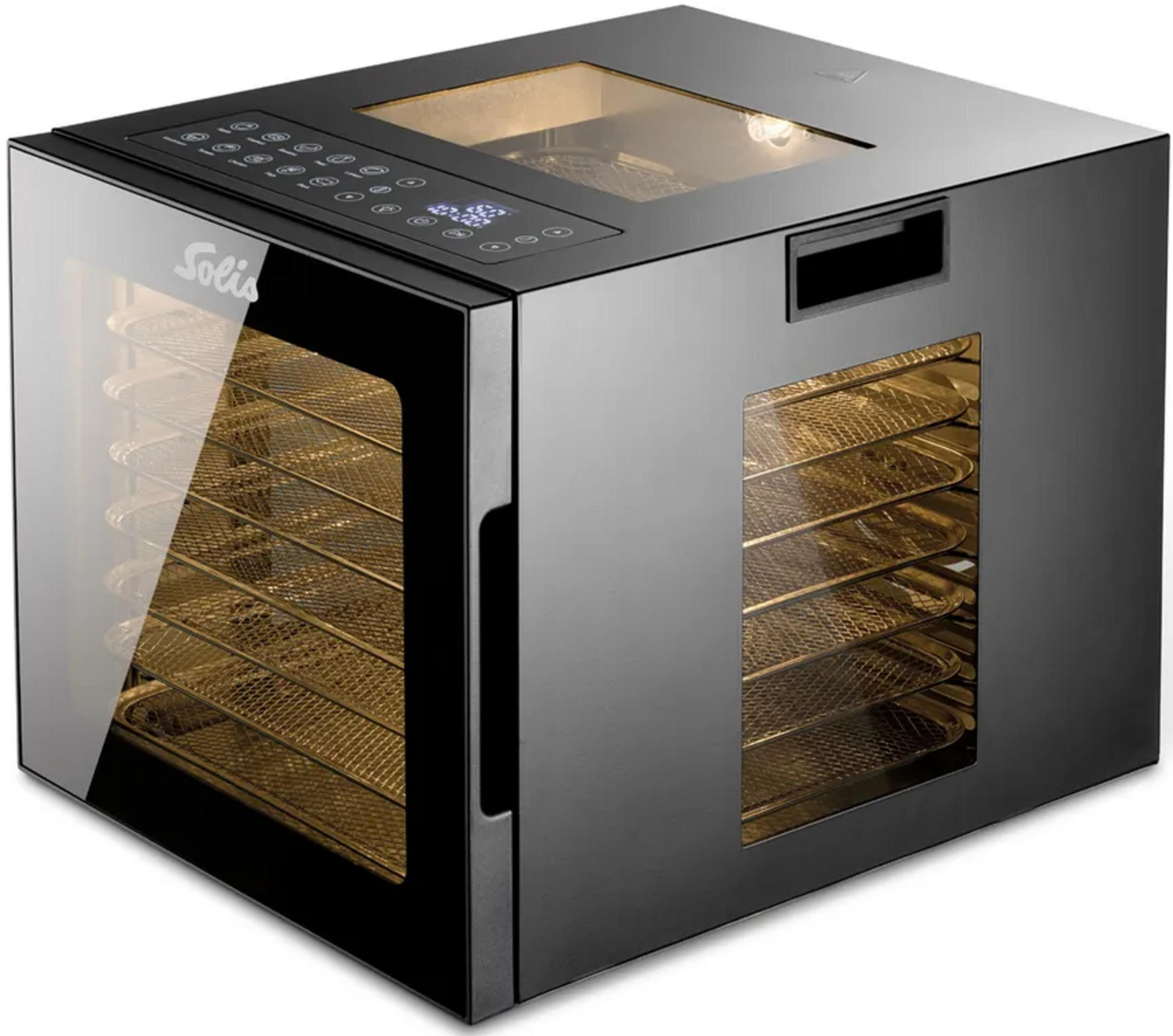 Ein schwarzes Dörrgerät mit sichtbaren goldenen Gittereinsätzen und einem Glasfenster.