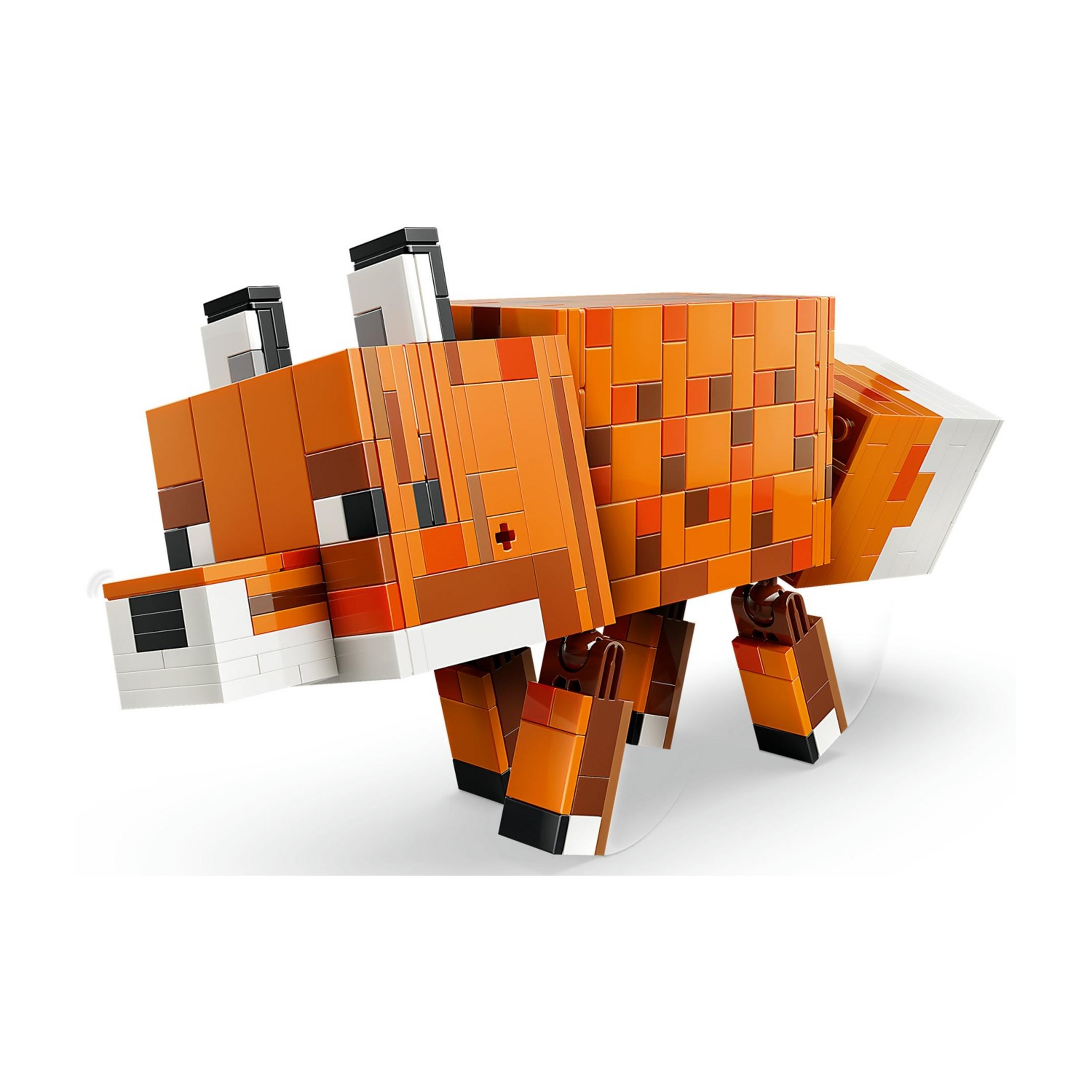Un giocattolo volpe arancione pixelato fatto di blocchi, con dettagli marroni e bianchi.