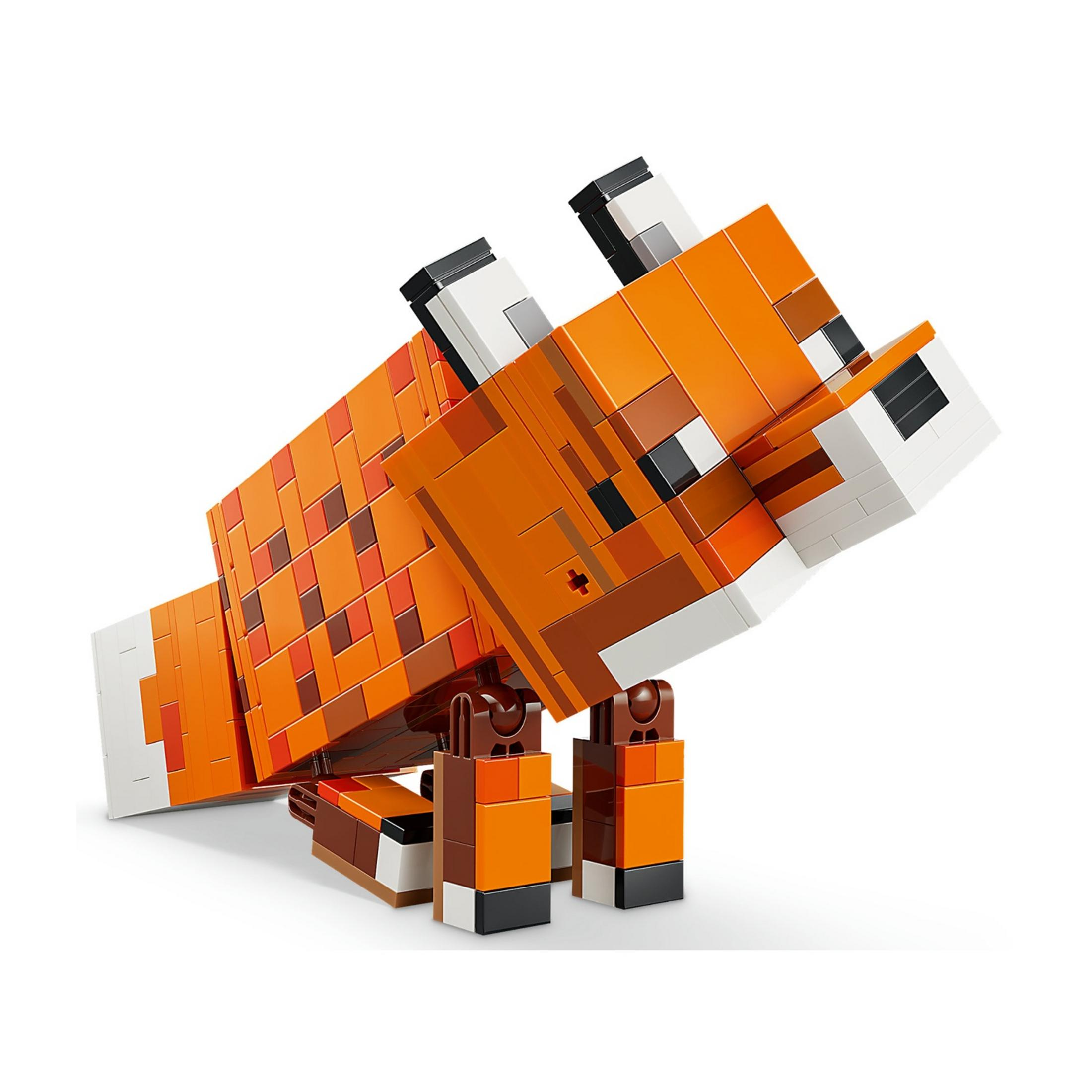 Figura di volpe Lego arancione, marrone e bianca, posata su sfondo bianco.