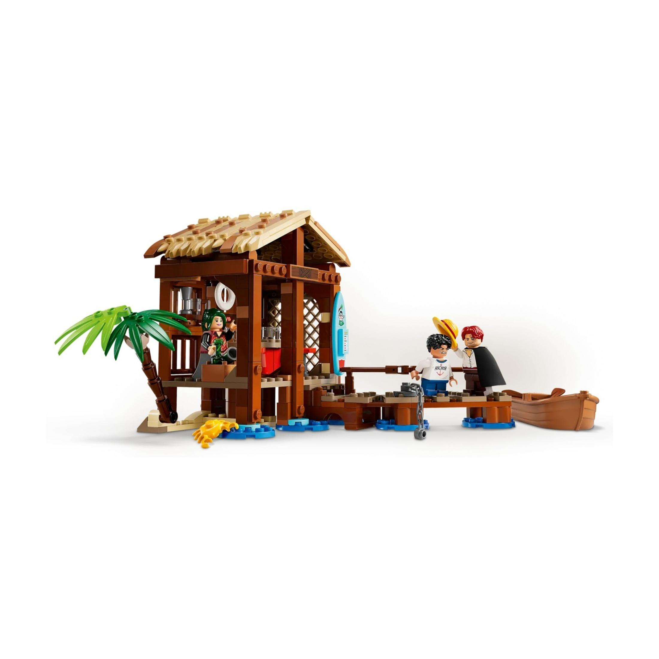 Una casa sulla spiaggia Lego con palme, figure e una barca su sfondo bianco.