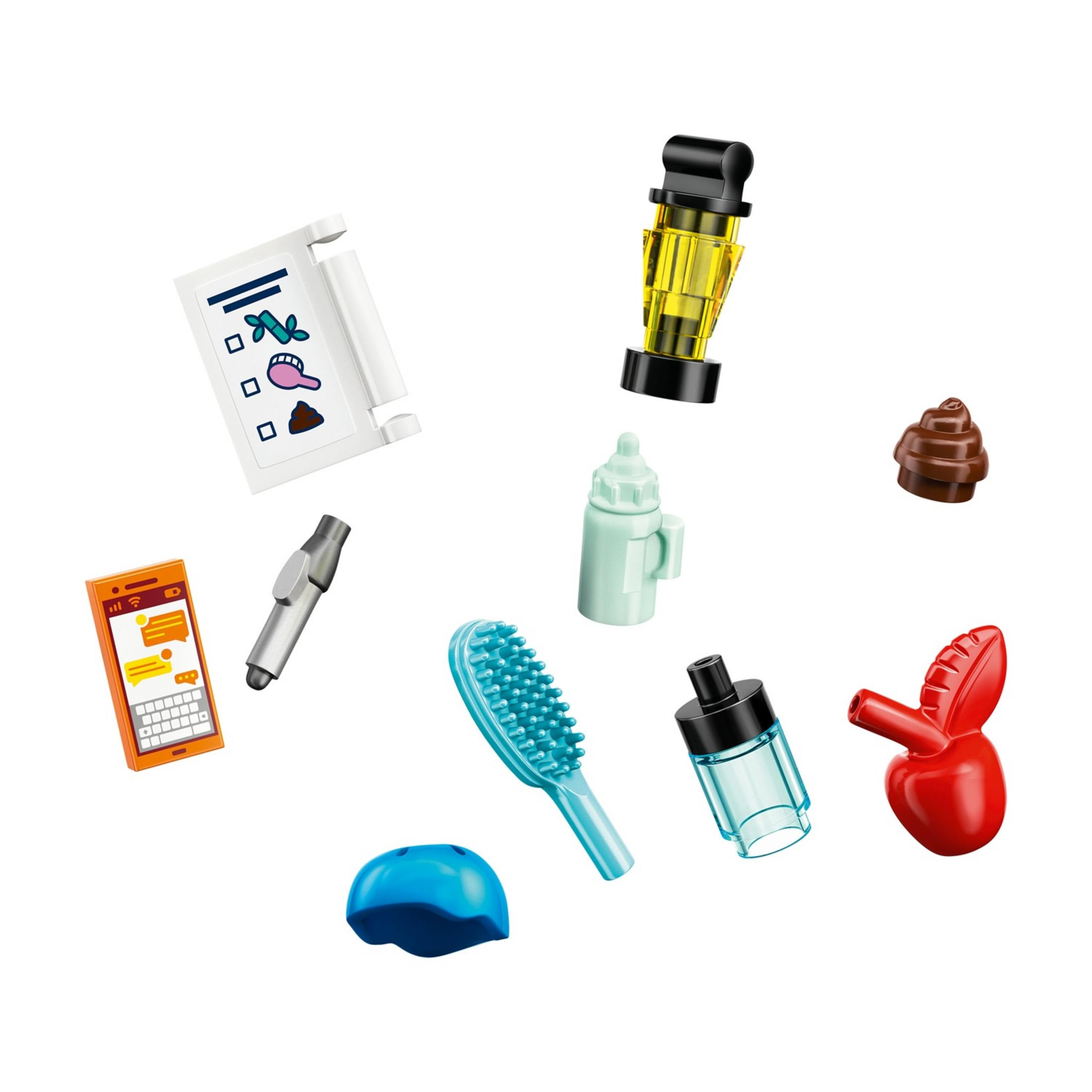 Pomarańczowy smartfon, lampka biurkowa, niebieska szczotka, butelka, jabłko, kask, butelka na mleko, kupa.