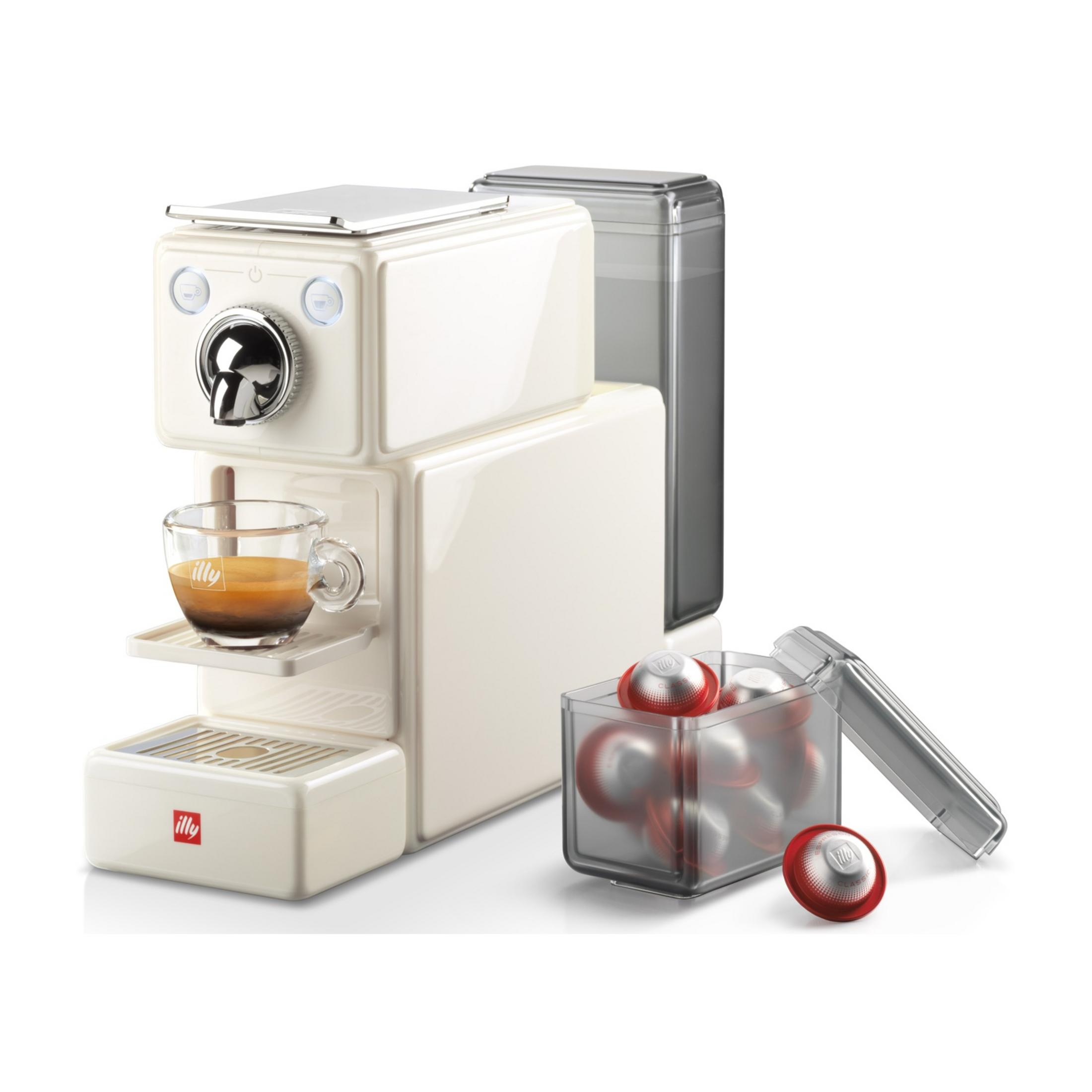 Una macchina da caffè bianca con una tazza di espresso e capsule accanto.