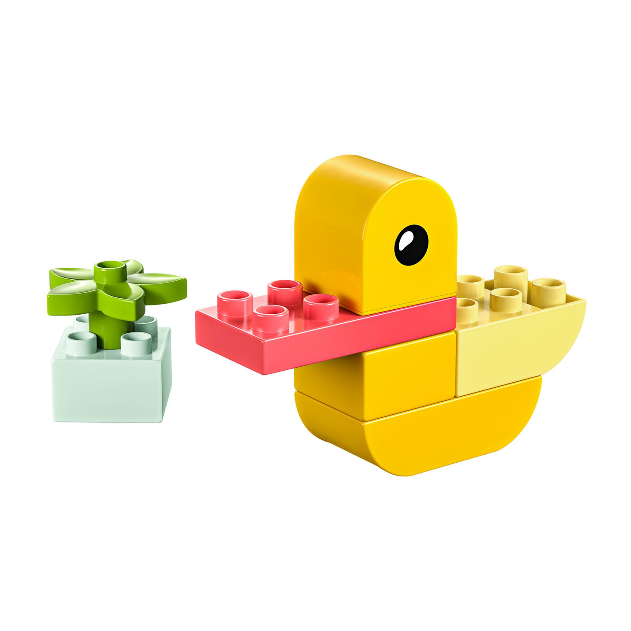Un'anatra Lego gialla con un vaso da fiori Lego verde accanto.