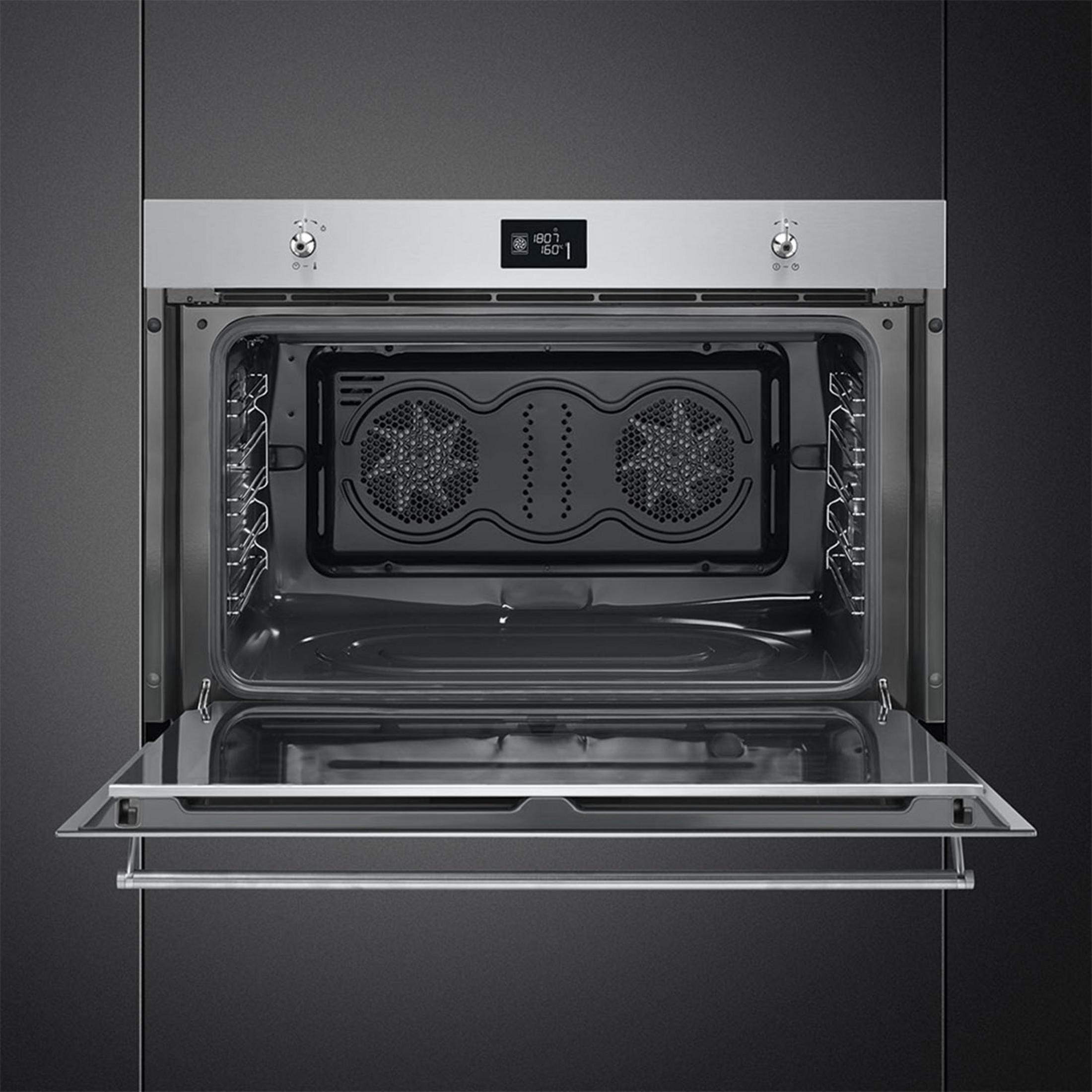 Un horno empotrado abierto con dos ventiladores y pantalla digital.