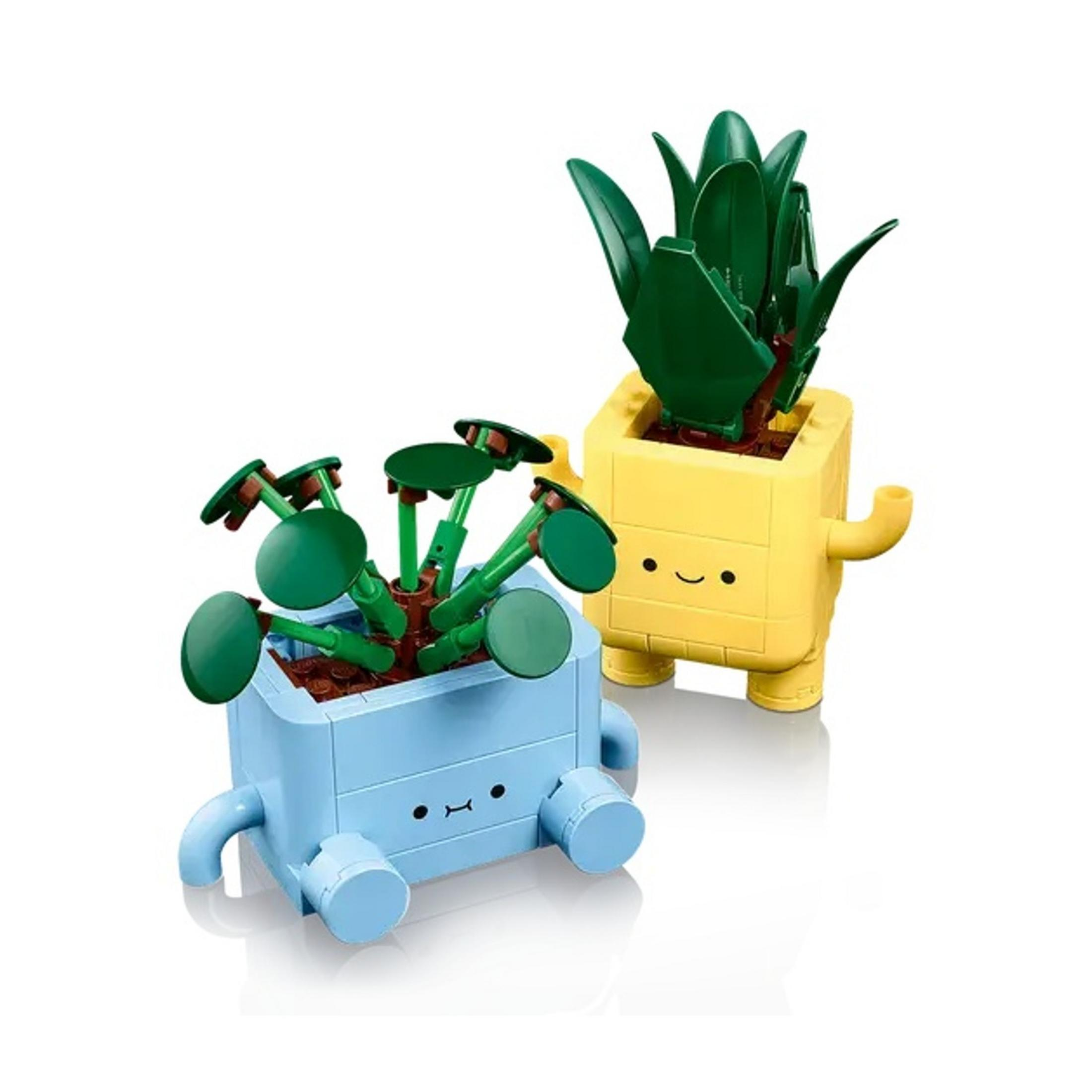 Dwa doniczki LEGO z twarzami. Jedna jest niebieska, druga żółta.