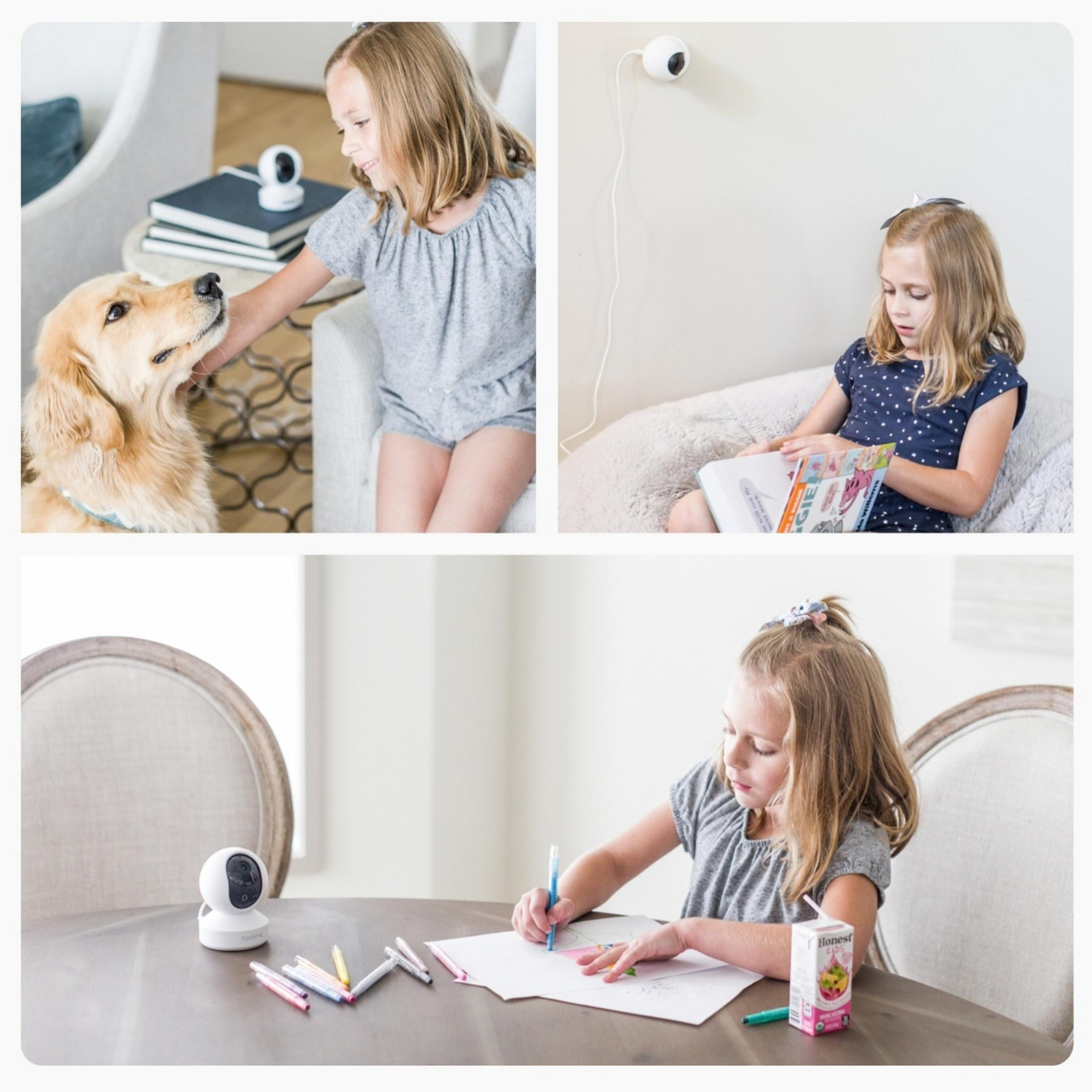 Dziewczynka głaszcze psa. Aparat znajduje się na stole.