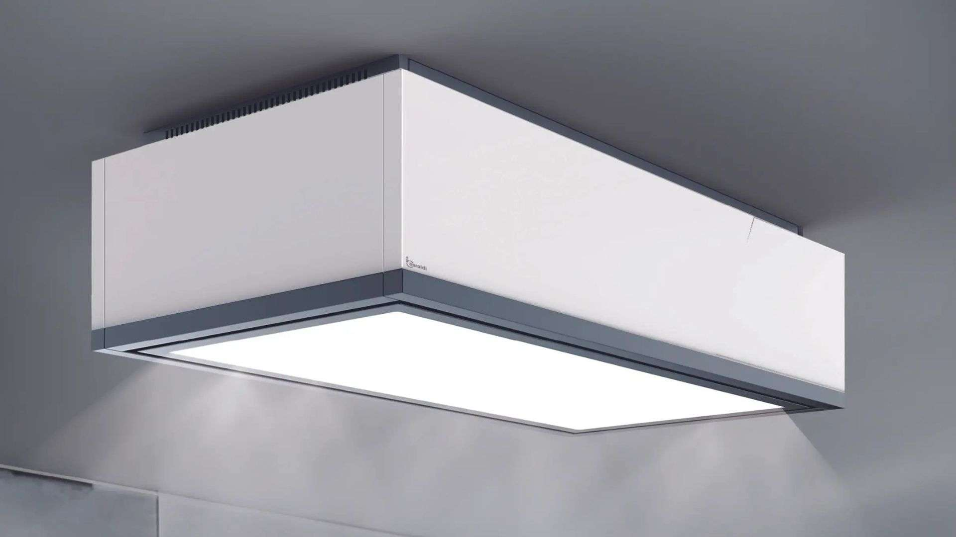 Una cappa aspirante bianca con accenti grigi è appesa a un soffitto grigio.