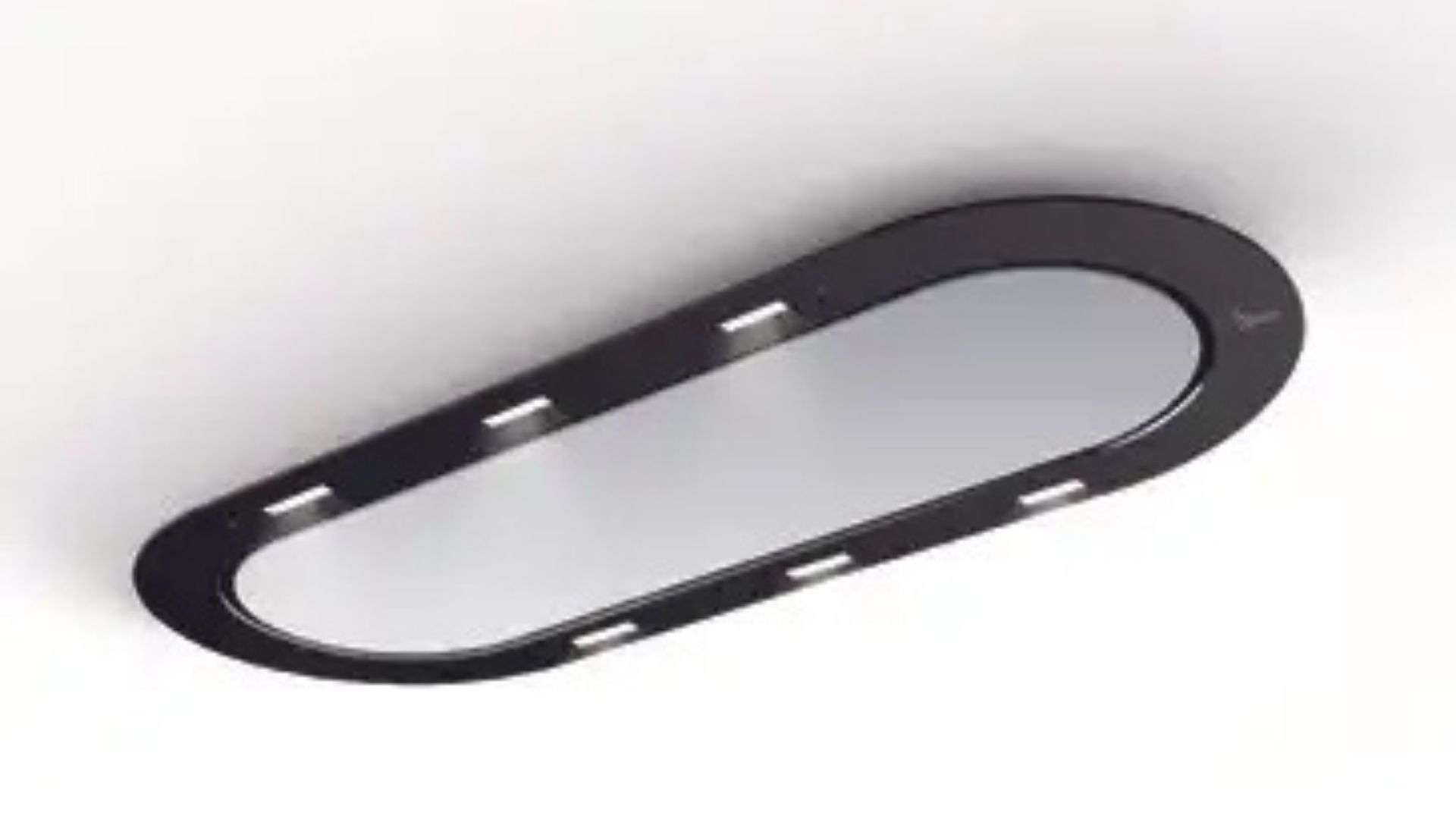 Uno specchio ovale nero con molte luci su una superficie bianca.