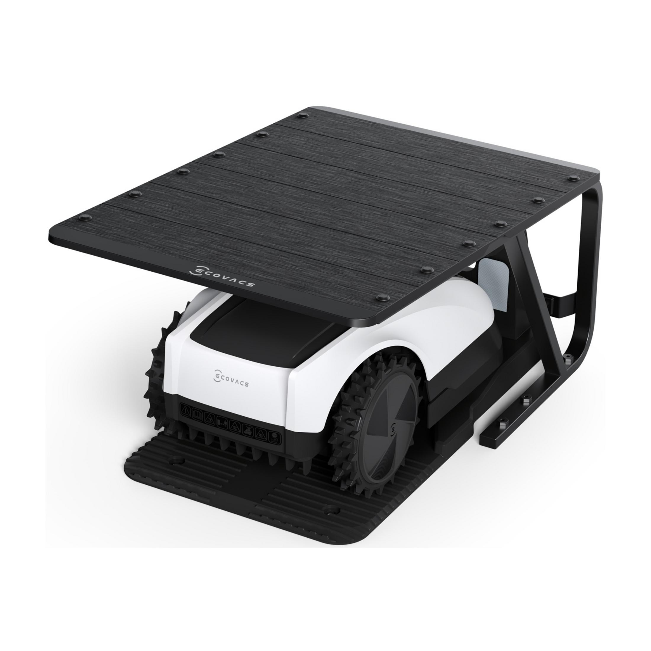 Un robot tosaerba bianco con ruote nere sotto un tetto nero.