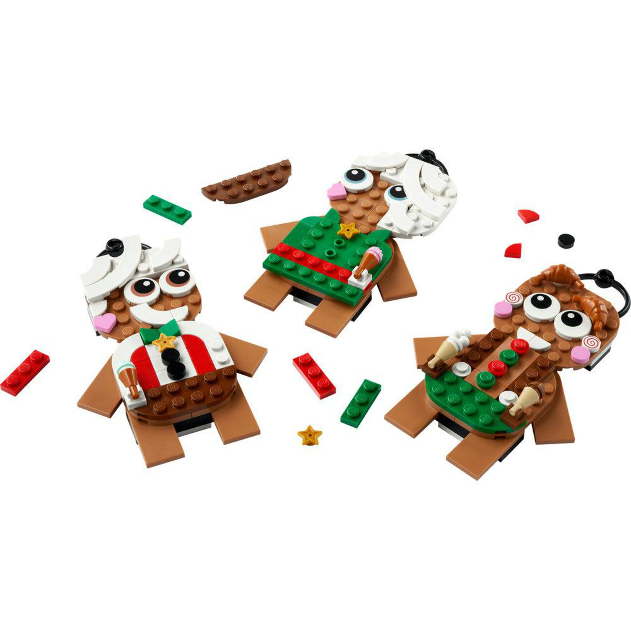 Drei Lego-Lebkuchenmännchen mit bunten Dekorationen und weißen Zierelementen.